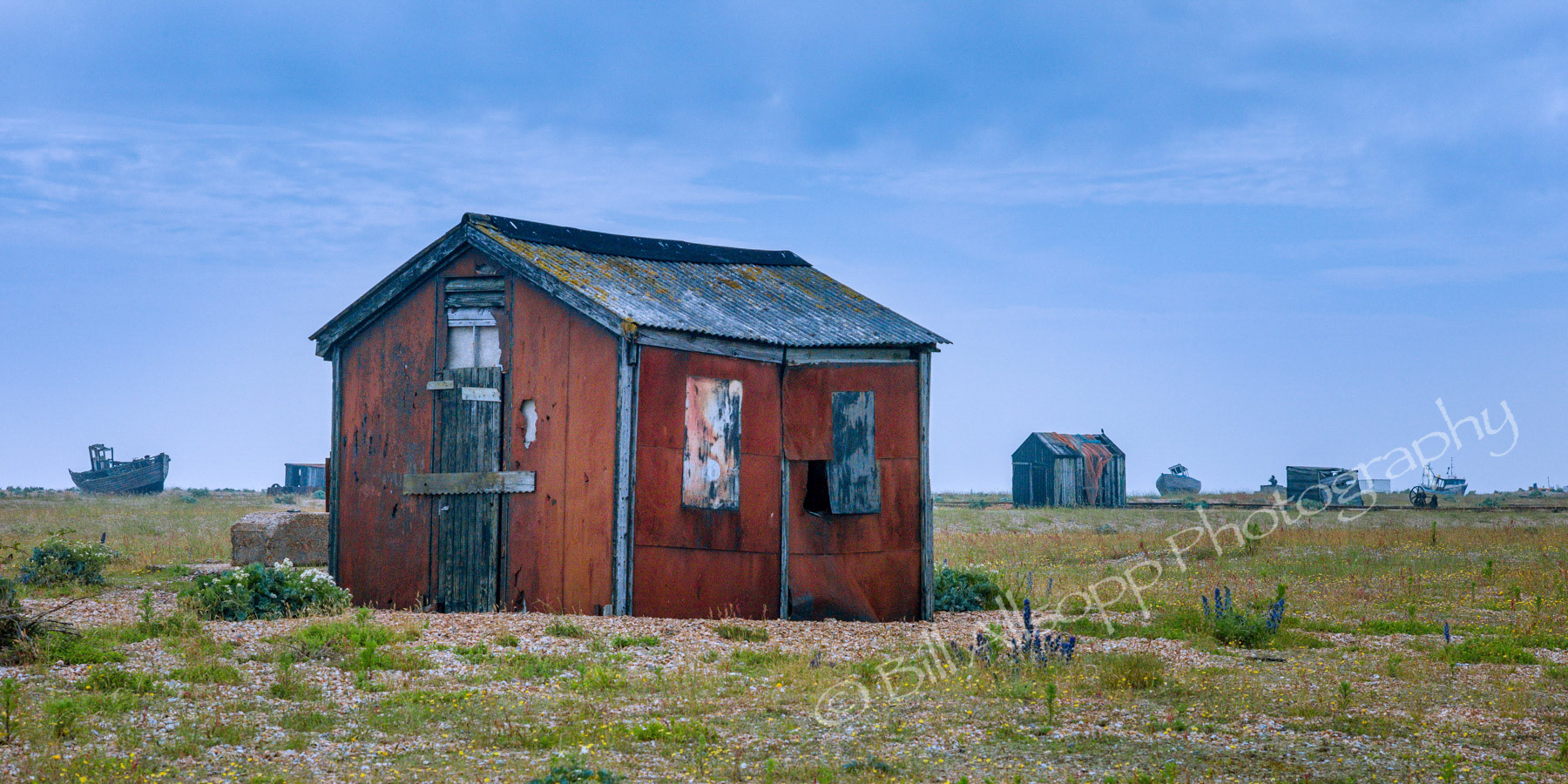 Fishermens huts and the hulks of old boats litter the beach at Dungeness.