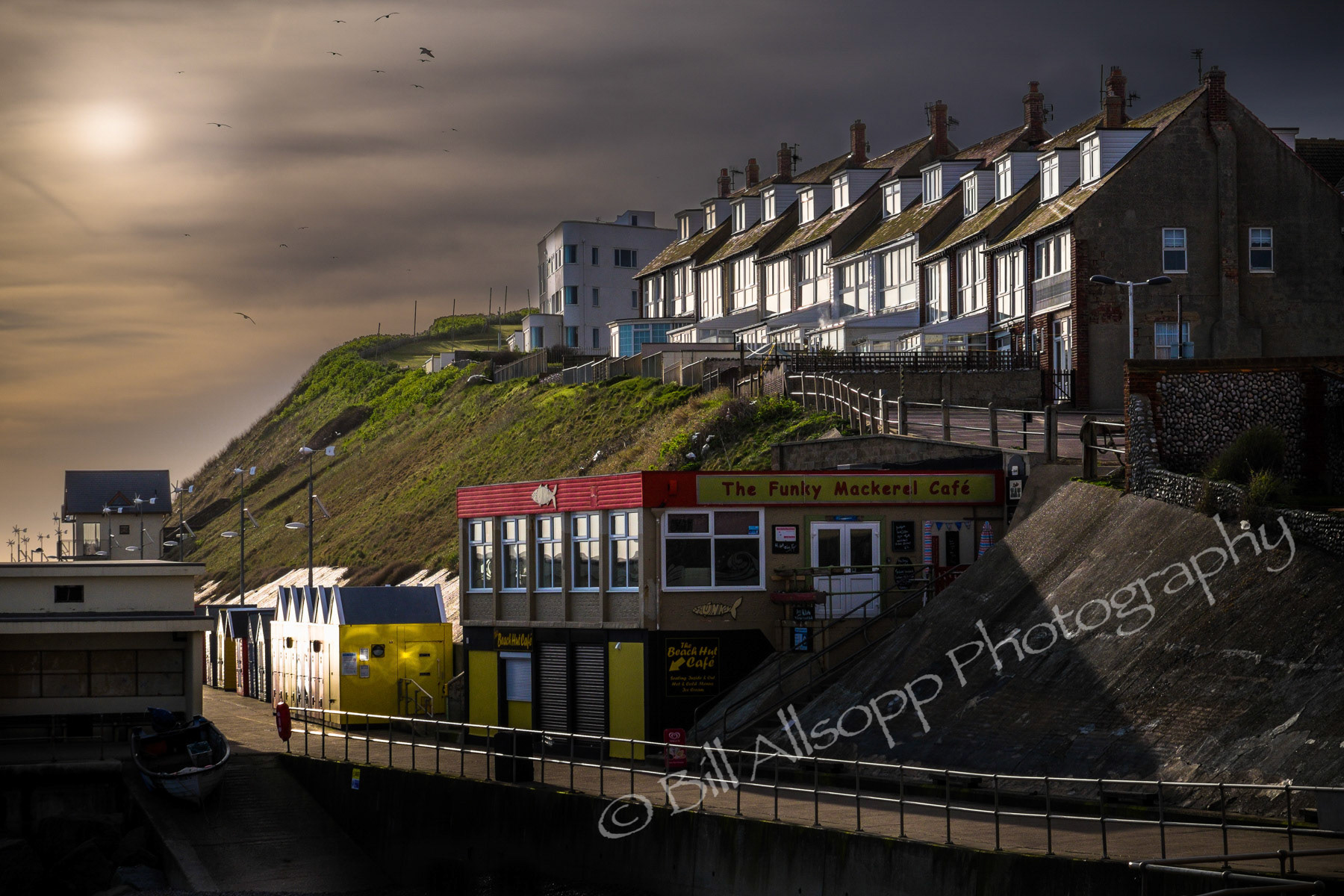 Low sun glances off sea-front buildings at Sheringham.