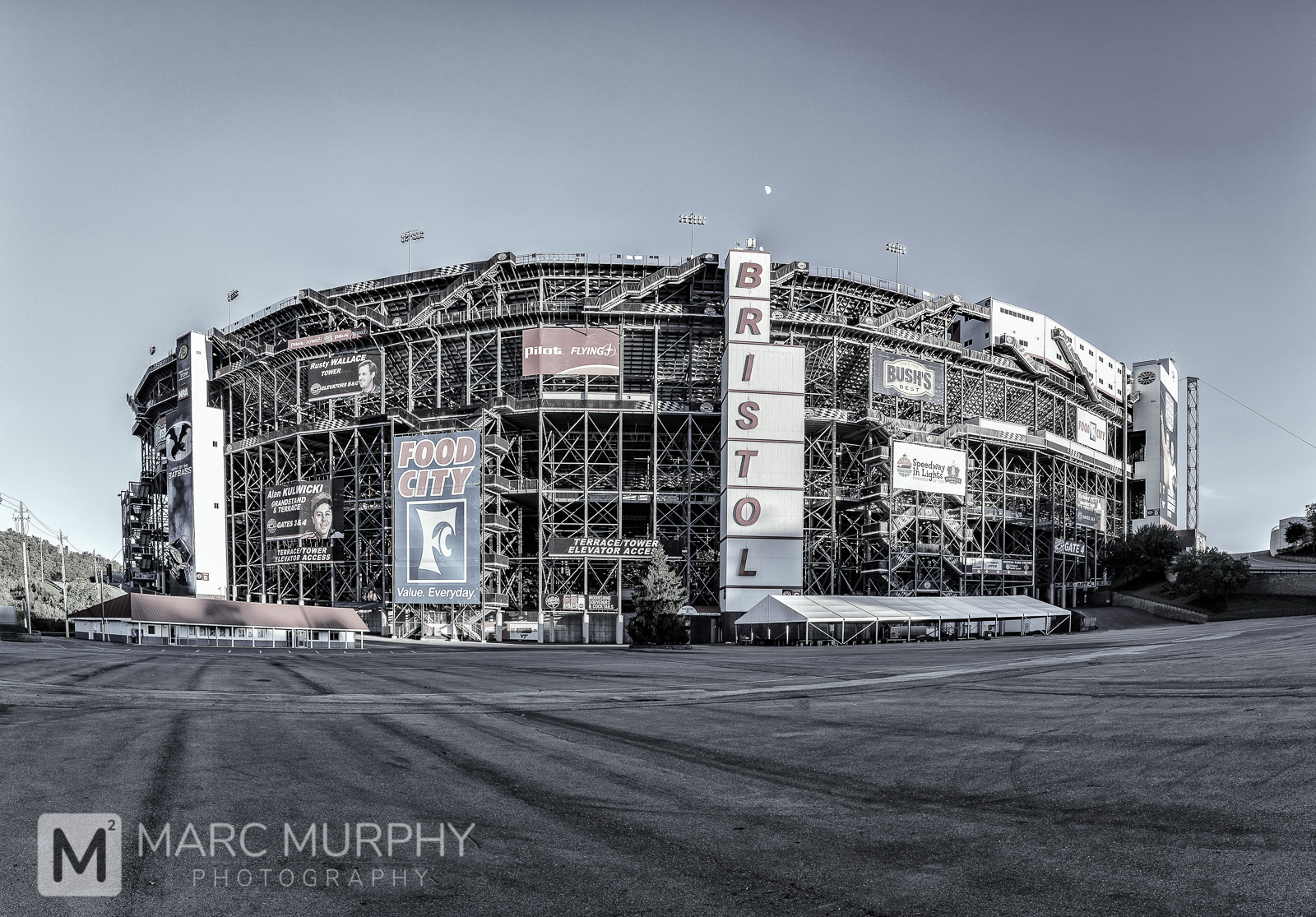 De-Saturated Exterior Panorama of Bristol Motor Speedway NASCAR Racetrack at Sunset with the moon in Bristol Tennessee