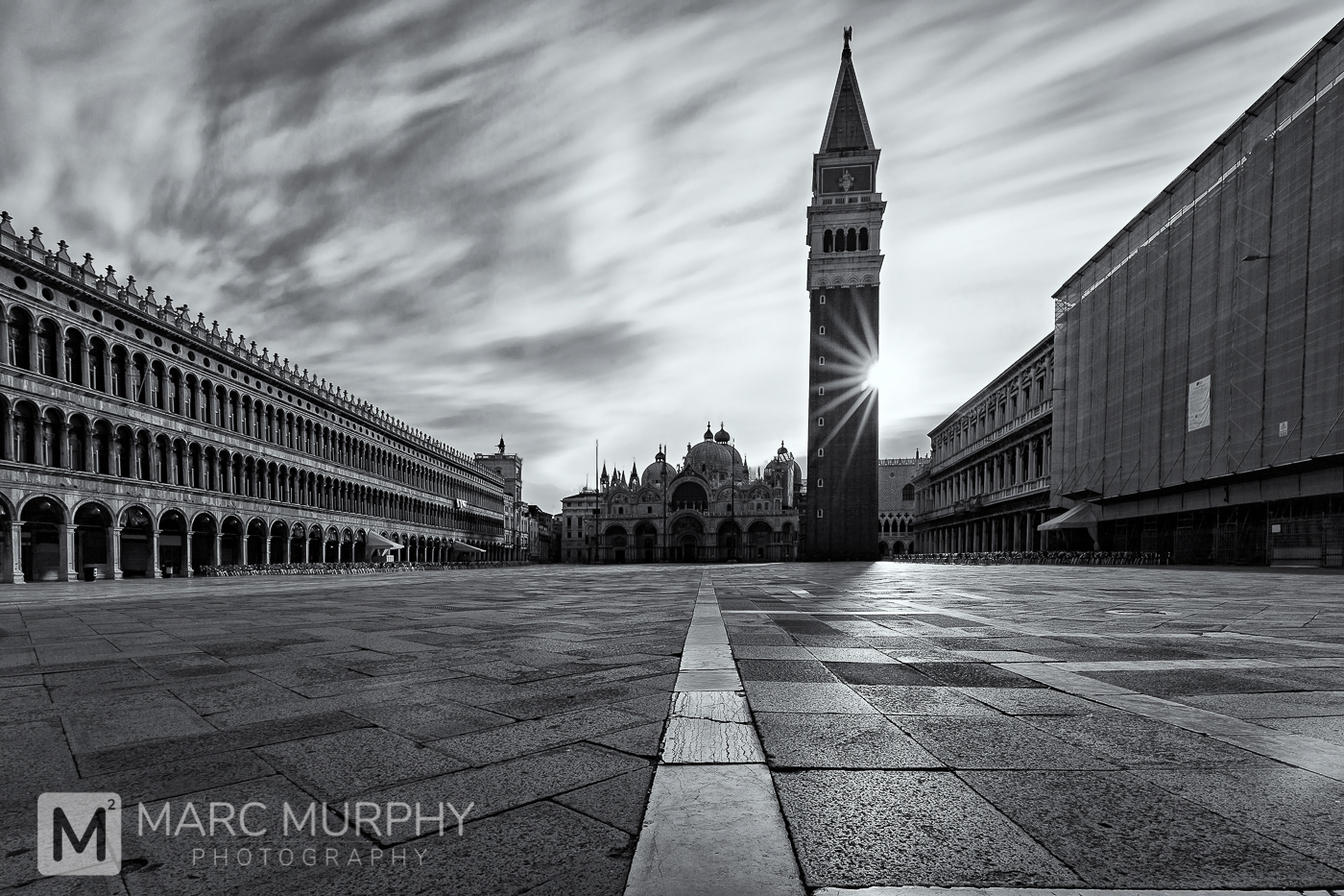 Black and White St. Mark’s Basilica and St. Mark’s Campanile in Empty St. Mark’s Square in Venice Italy at Sunrise with Sunburst