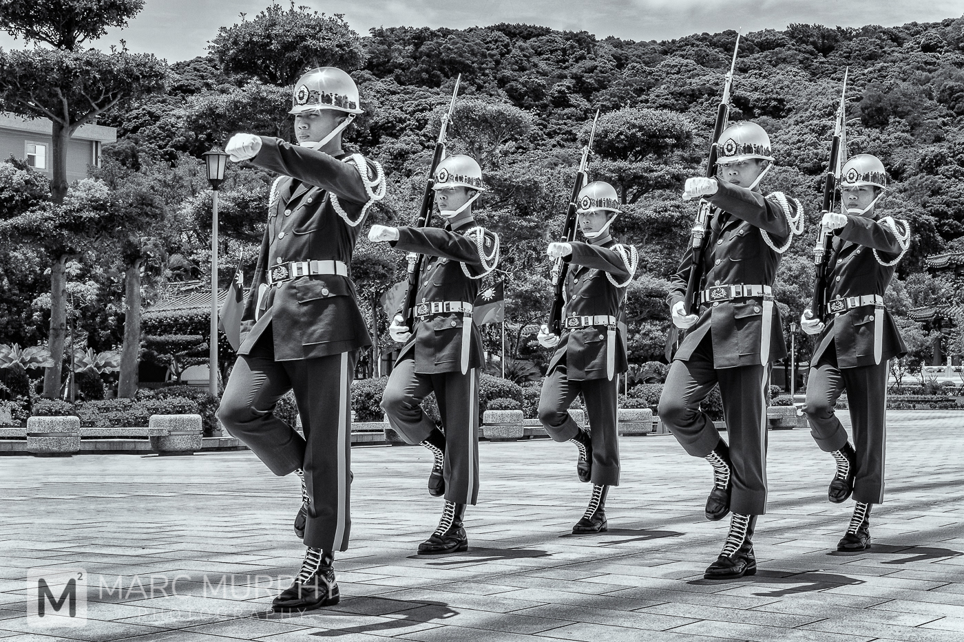 Black and White of Soldiers in Uniform with Rifles During The Changing of the Guard Ceremony at Taipei Martyrs' Shrine in Taipei Taiwan
