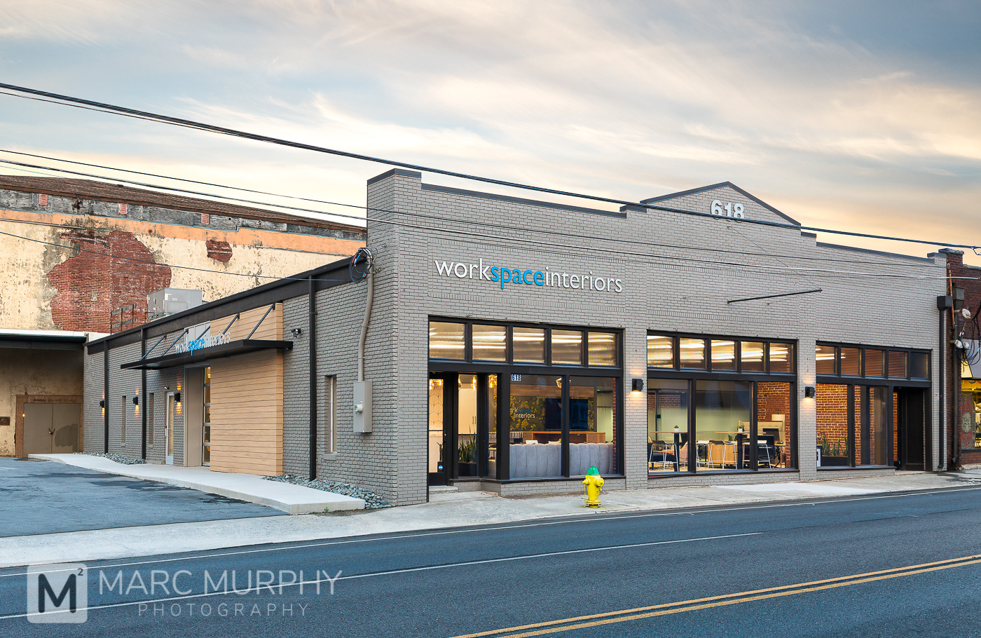 Workspace Interiors Office Building at Sunset with Interior Lights On