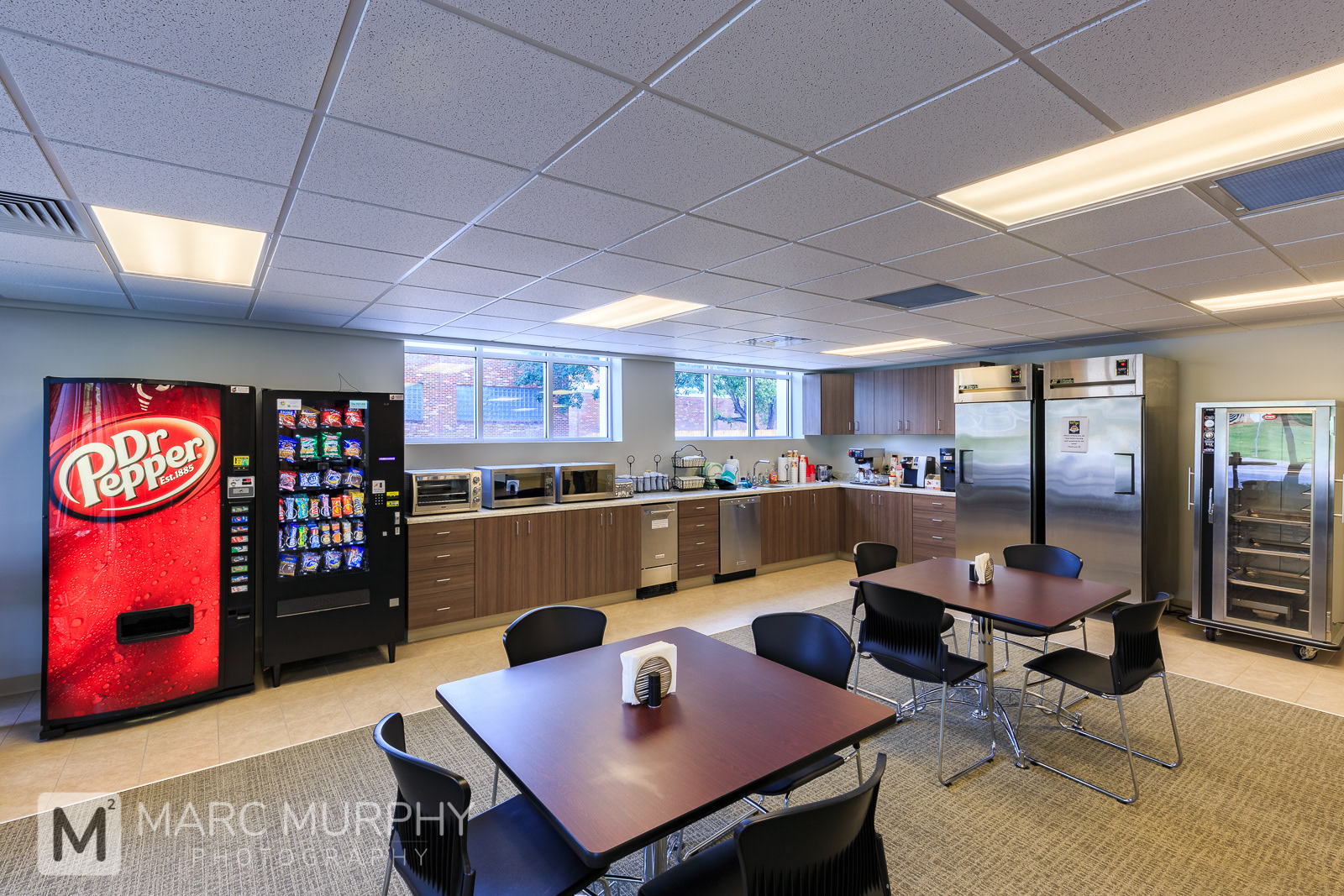 Corporate Office Break Room with Tables, Chairs, Vending Machines, Refrigerator, Freezer and Other Appliances