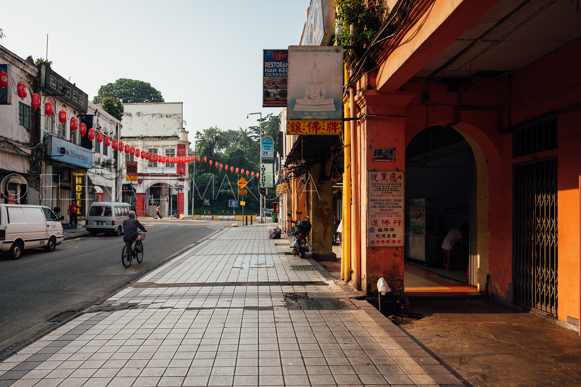 Man riding a bicycle down the street of Chinatown, Kuala Lumpur, Malaysia