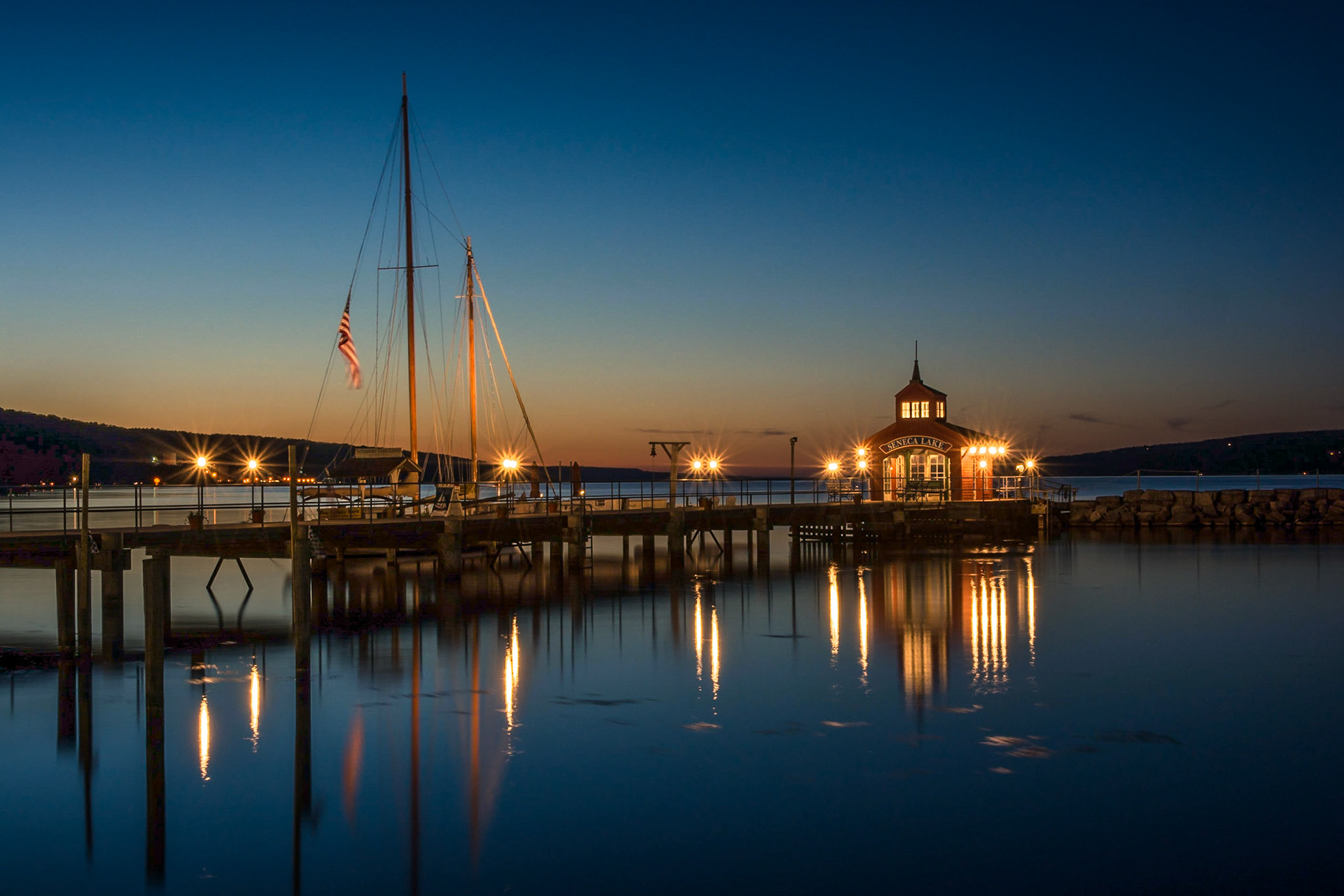 The Seneca Harbor in Watkins Glen, NY glows on a calm, summer evening