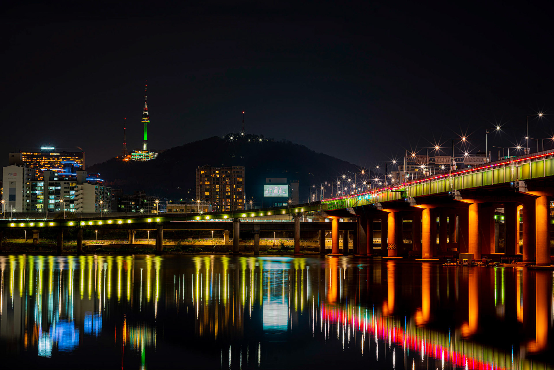 Seoul cityscape bridges, buildings and lights at night along the Han River