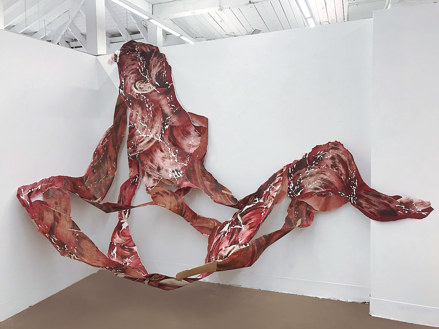 Red ballpoint pen and acrylic paint on Arches rag paper and brown butcher's paper. Large scale sculptural drawing installation with surface tears and layers. Installed in a corner.