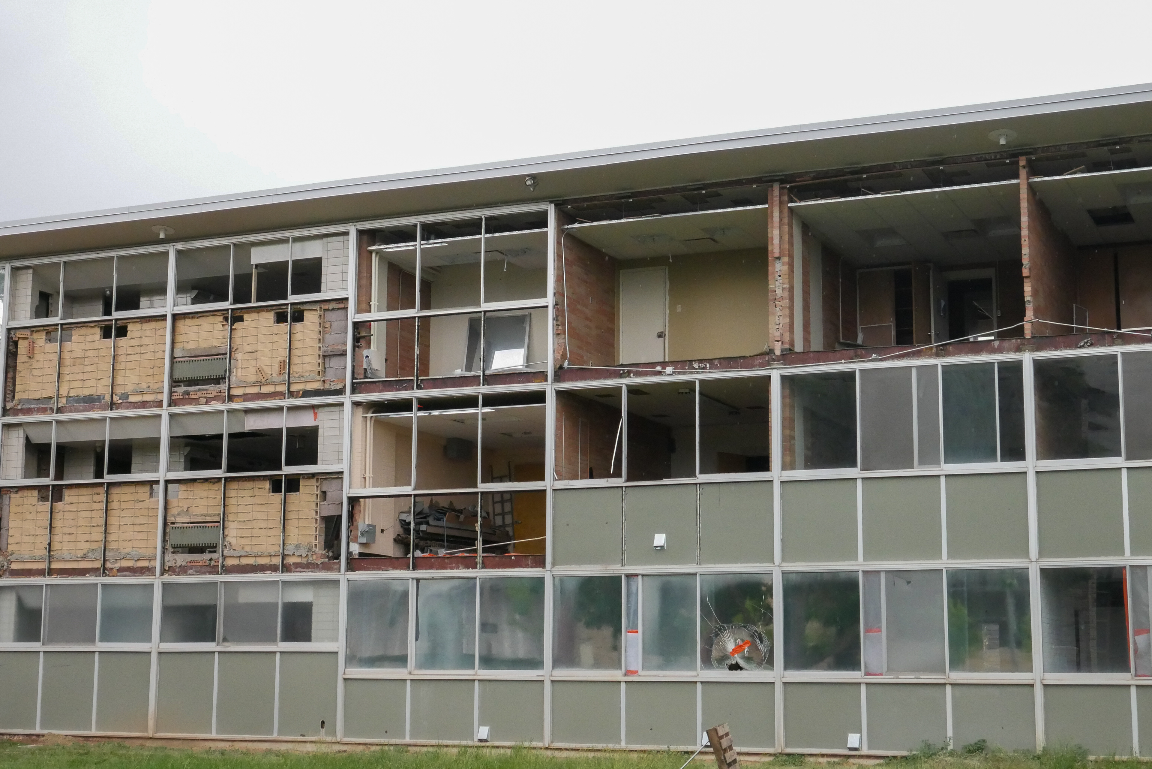 Partial removal of windows and sage green panels, south-facing side of the SE wing