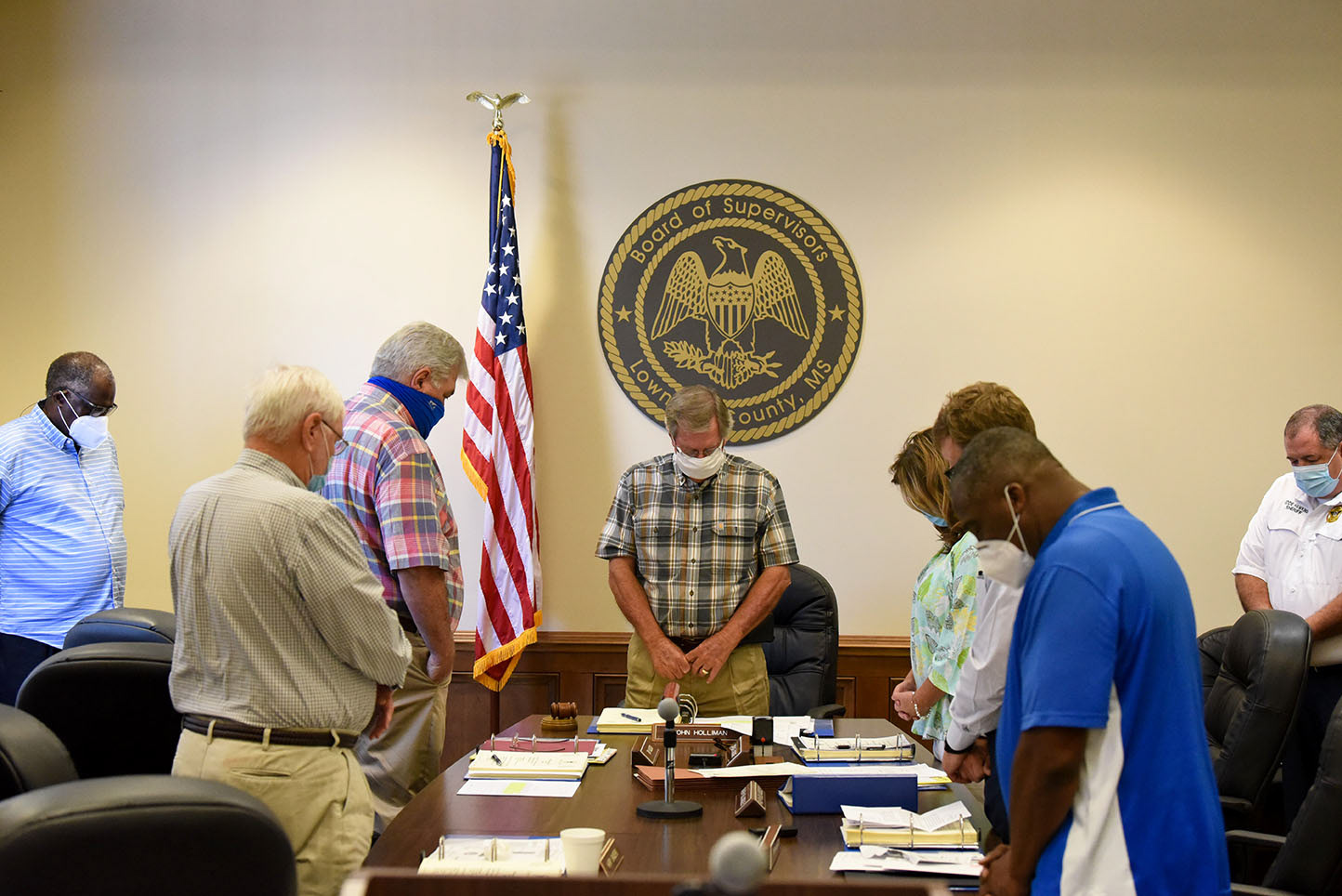 Supervisors pray before starting their meeting on Monday, August 3 at the Lowndes County Courthouse in Columbus. District 5 County Supervisor Leroy Brooks stands in the corner of the room instead of at the table as an act of protest against District 1 County Supervisor Harry Sanders and the racist remarks he made about African Americans on June 15.