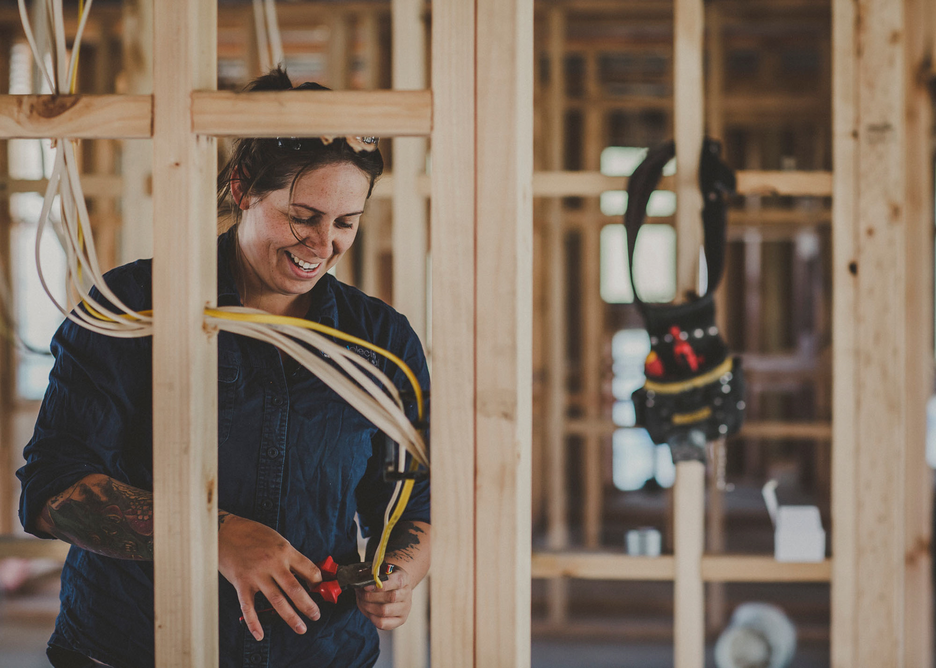 Electrical tradesperson working the wiring of a new build - photo for website content