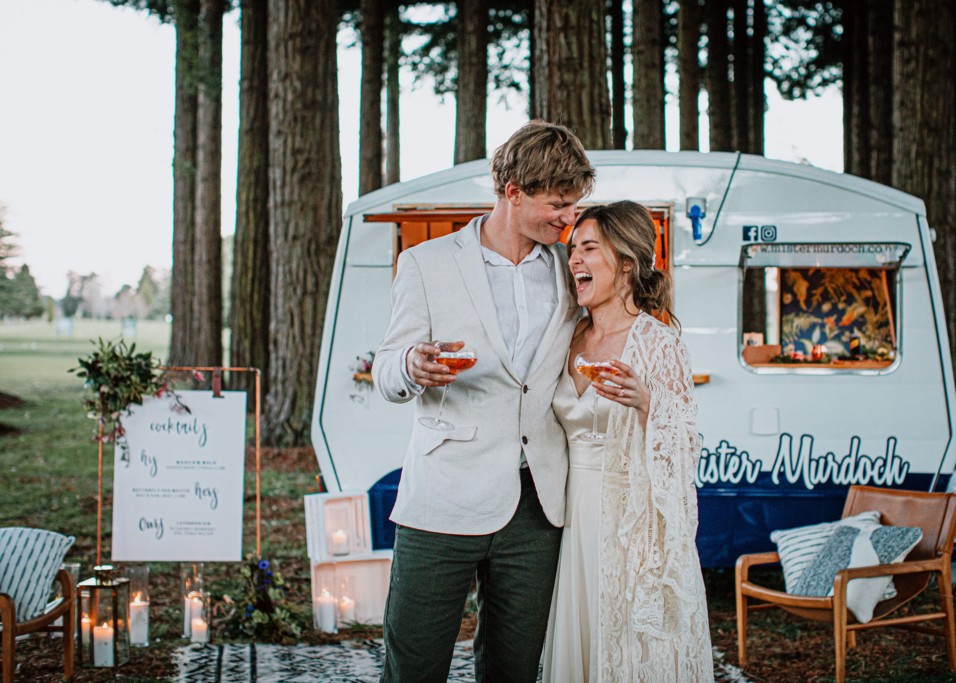 Ashleigh and Wilson laughing and enjoying a rose wine in front of Mister Murdoch Caravan Bar.