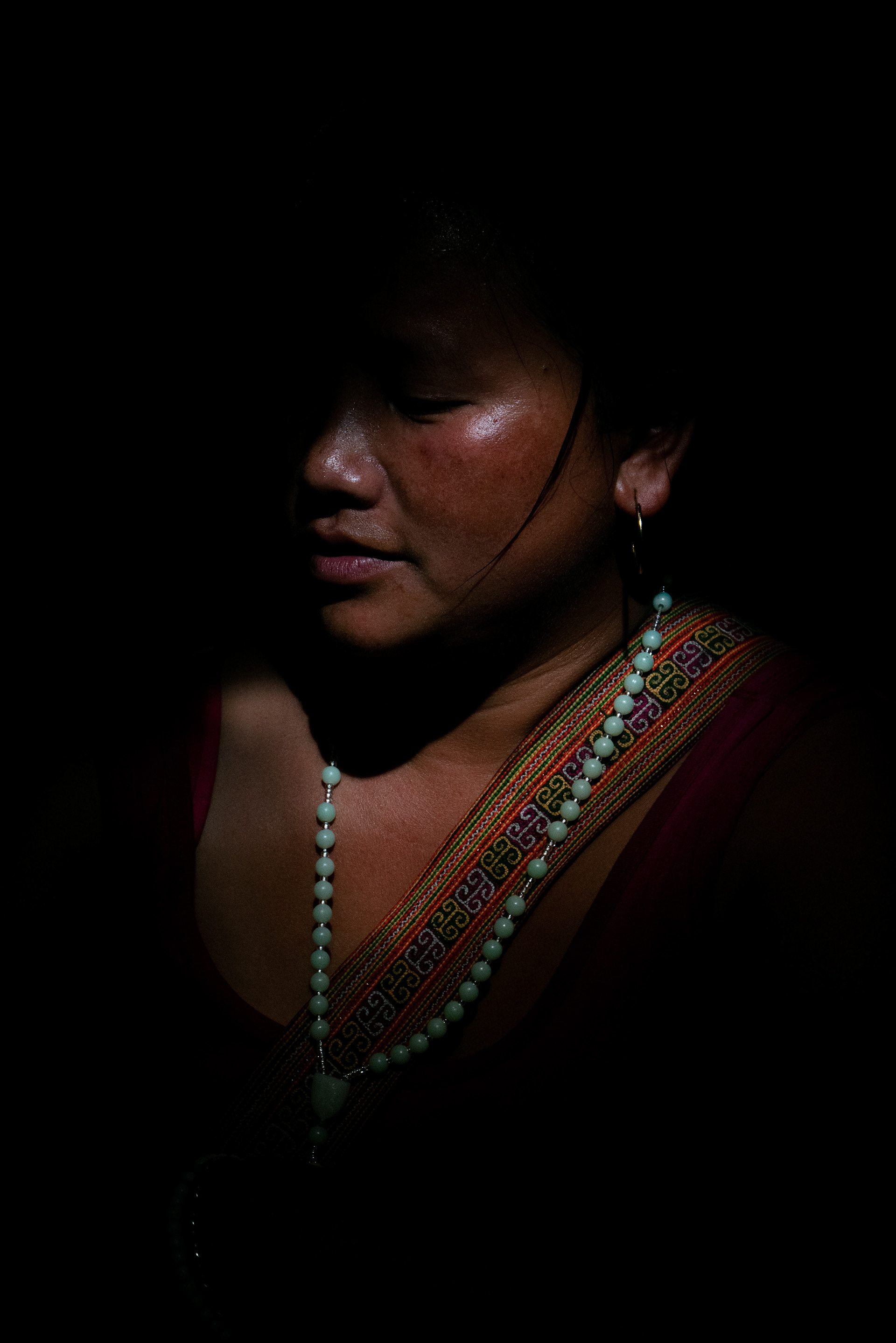 In Sapa, members of the Black Hmong tribe commute daily to earn for many what is their only income from selling handmade goods to the crowds of tourists. With beautiful handmade Hmong silver earrings hanging from her ears, Geng explained to me this trade is a necessity for many members of her Village. The income from tourists living in economically richer, but arguably, emotionally poorer, countries, with their pockets full of cash, is now a compulsory source of income for the communities living around Sapa. Geng works as a tour guide, trekking around her village with people from across the world an average of twice a week, provided it’s not the high season of July to August, where flocks of tourists migrate to the beauty of the mountains, and income for many families in the village of Ta Van, and those that surround it, is high. When she was a young girl, living with her father and mother, of which the latter was very ill and self-medicated with opiates that are grown in the area, money was tight. Even so, she explained to me that the community always helped her and her siblings when there wasn’t enough food on the table. In an attempt to combat the families financial insecurity, Geng and her friends would commonly walk or motorbike to the City of Sapa and sell the homemade items that are sold in their thousands nowadays, to tourists. Ten or Fifteen years ago, when Geng was young (she’s now aged 25) There would only be 10 or twenty people selling on the streets of the city. Now, as your feet touch the solid ground of the mountain on arrival to the city, the same number of sellers approach you within your first five minutes there. With many of these sellers being young children with even younger children on their backs, Geng believes that the industry is deadly to the education of the community. She explains that she doesn’t agree with way mothers will make young children stay up as late at ten o’clock, with their even younger siblings on their backs to attract more empathetic tourists, and make more income. Her children, Ma and Ta, aged 7 and 5, go to the nearby primary school Monday to Friday, she has never asked them to sell on the streets and hopes she never has to, because in school they will learn English and other skills, that will perhaps take them to university in their later years.