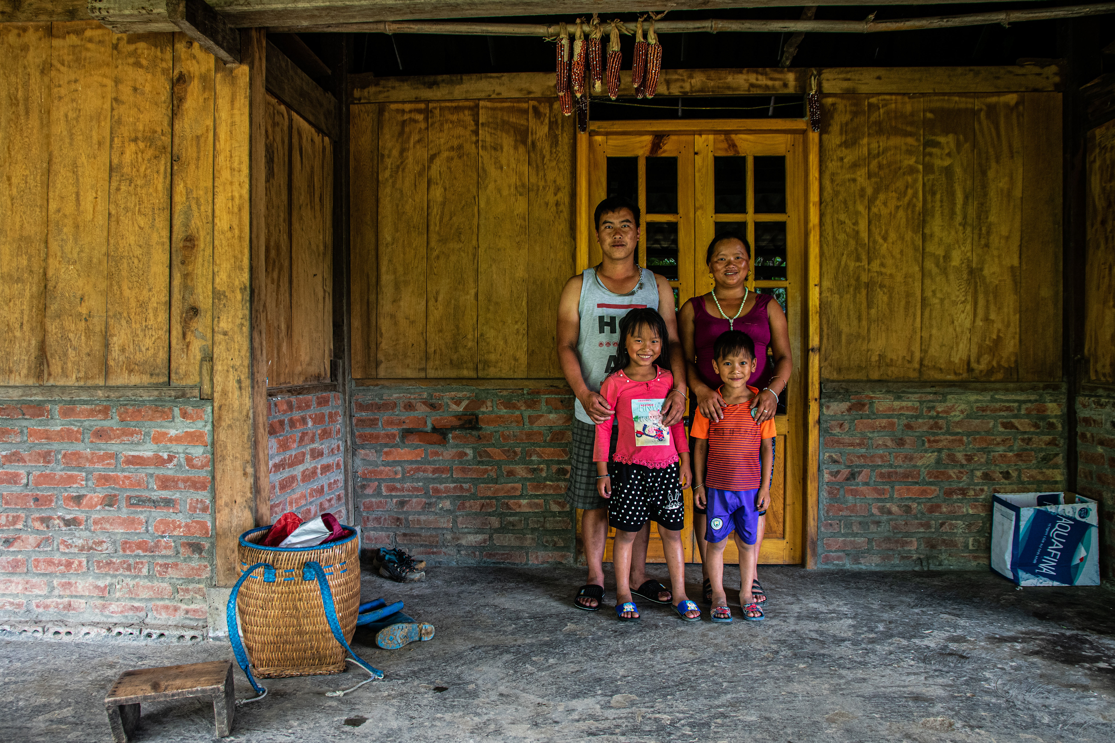 Not only does Geng lead treks, but her and De have been renovating the house constantly over the past few years in an attempt for its wooden walls and concrete floor to evolve into a fully established homestay. Currently, she houses guests that sign up for a 2 or 3 day trek through the mountains with either herself or her sister, Na. Her house can currently accommodate up to 13 people, this meaning, however, that Geng and the rest of her family are forced to inhabit only one 4 meters squared room with one double bed when it comes to sleeping, but Geng and her family are dedicated to their guests and will bend over backward to provide for them.. When entering Geng’s home and seeing the beauty in its simplicity, I felt embarrassed. Embarrassed that I’d let myself be fooled by advertisements. Embarrassed by all of the hundreds of unimportant possessions I own. Embarrassed by all the times I’d stressed that I needed something when there was no real necessity in my want, other than a need to feed my greed. The house was clear and simple; the first room consisted of 4 beds, a tv, a fridge, a water holder whereby the family boil enough water for the day in the morning and then use to drink from for the rest of the day, a wooden table, and a stack of plastic chairs. The rest of the home consists of a few small rooms, separated by either wooden walls or curtains. A year prior, the house was open, with no private rooms whatsoever; De, Geng’s husband has been using much of the money earned by Geng to improve their house. He next hopes to install a window to let natural light fall into the dark communal area. Beside the house, there is a toilet, shower, and a small kitchen with a table, and open fire on the floor. Furthermore, a mountain stream is diverted into a water pipe that constantly flows into a corner depression of the concrete floor, and then out through a hole in the wall. This acts as their washing machine, dishwasher, and sink.