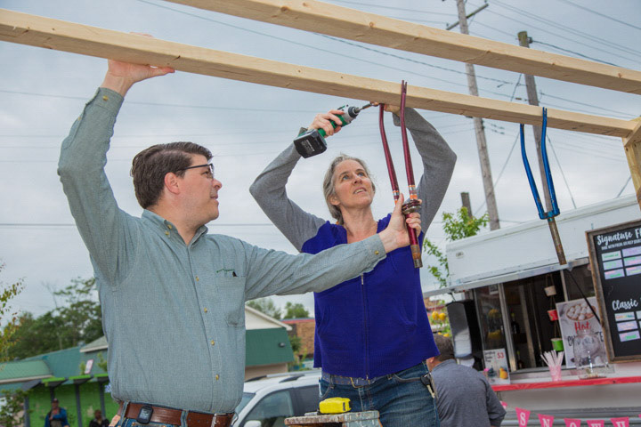 Tim Holz and Linda Erzinger setting up an art installation.