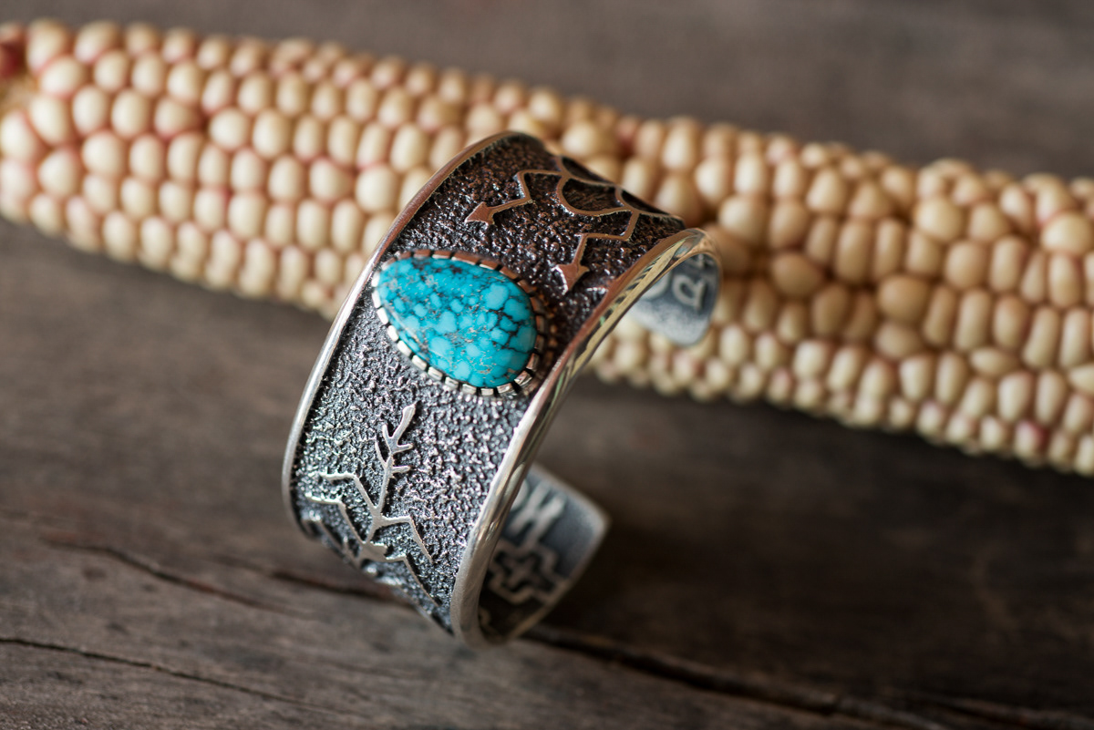 A cuff with corn design, tufa cast with turquoise by Steve.