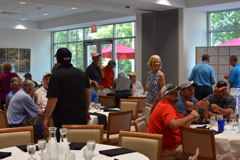 Returning teams compare stories over food and drink