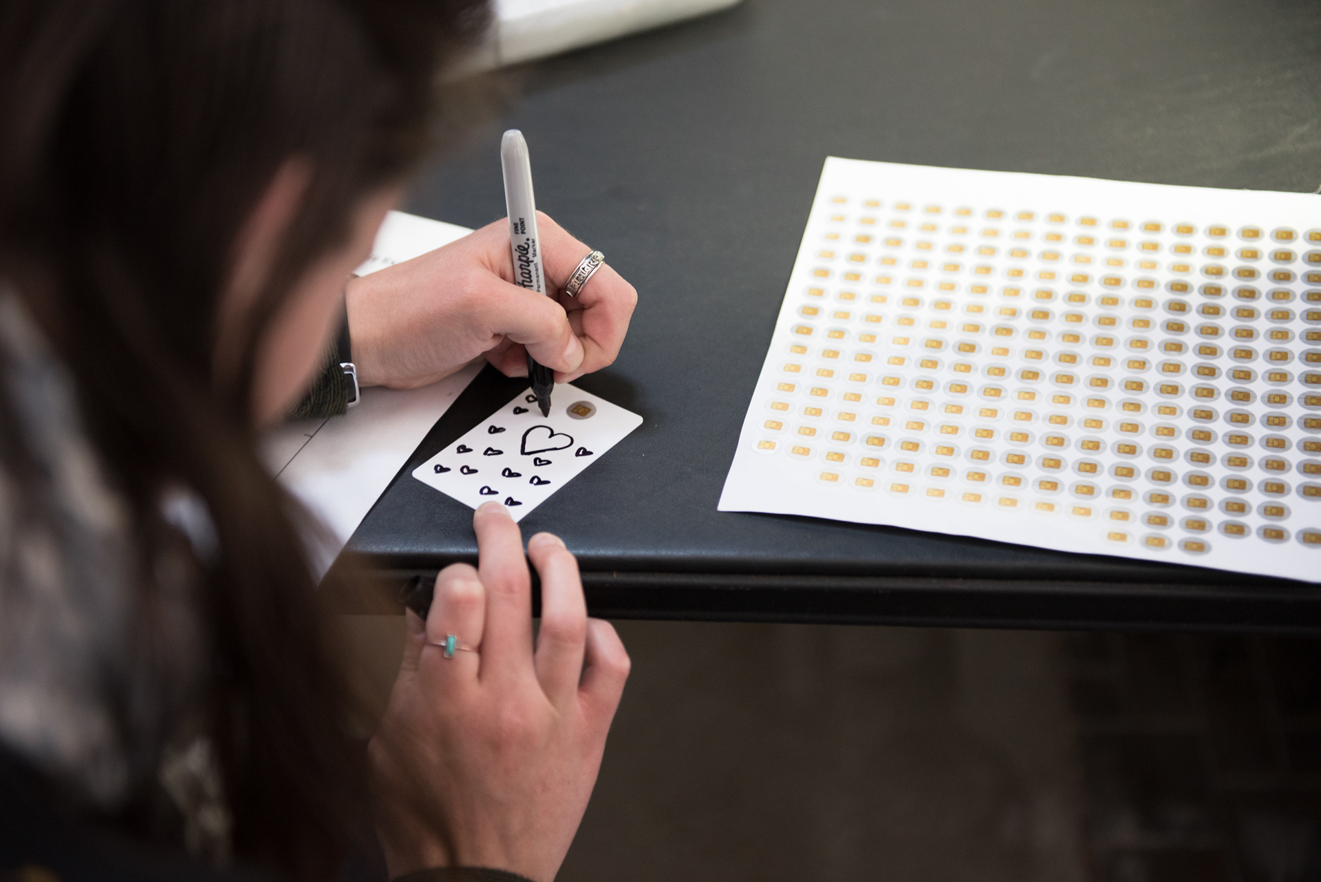 Participant drawing image of her digital identity on a credit card blank.