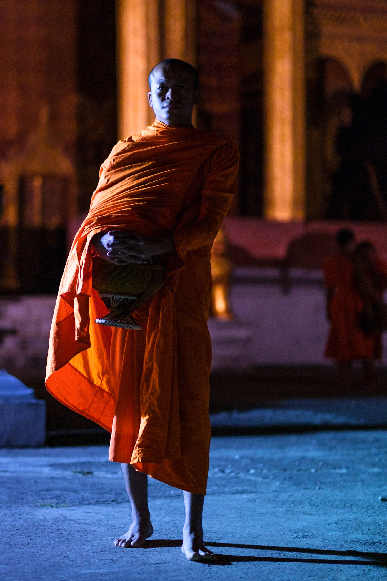 Buddhist monks during their morning routine / receiving food from neighbours