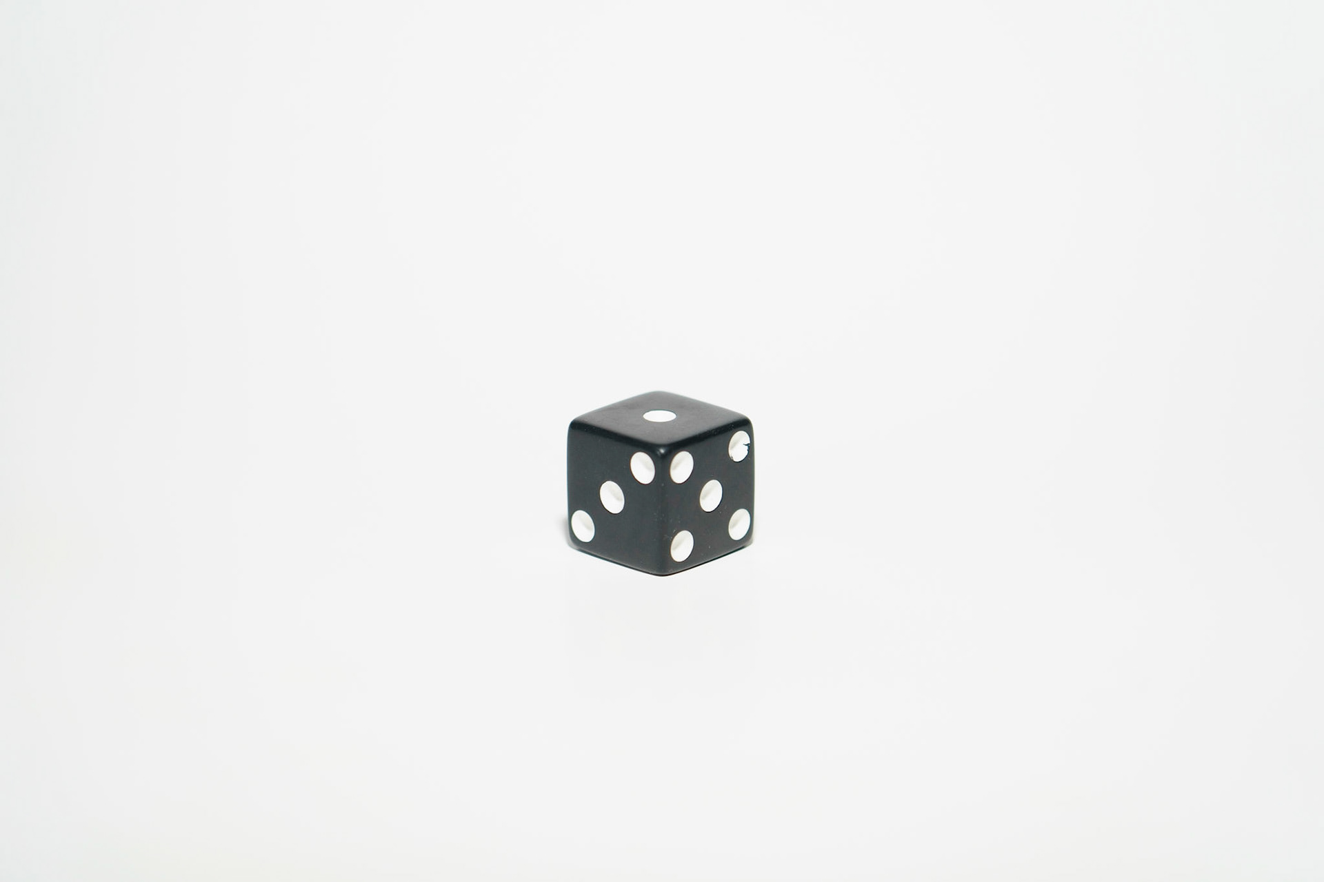 High Key Image: Dice on white paper, 20201107, MILLER, Utilizing the white backdrop I was able to get this high key image affect and show true white, while still maintaining the black integrity of the dice in the space. Camera Settings: Sony A7II, ISO 200, 105mm, f4, 1/20s