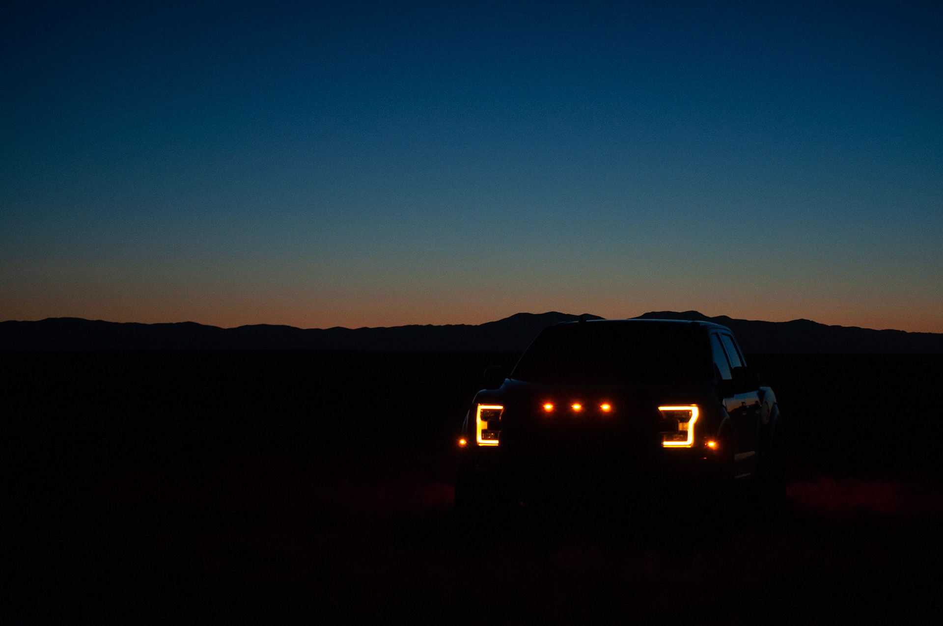 Raptor Lights: 2019 Raptor, capture the iconic front lights,20200926,rural Idaho, Miller, I wanted to capture the iconic front lights of the raptor, in the dark, but also keep dusk in the background maintaining a balance between the two light sources. This shot I adjusted the amount of light coming in to find that balance. Camera Settings: Nikon D500 ISO 200, 55mm, f/4, 1/20s