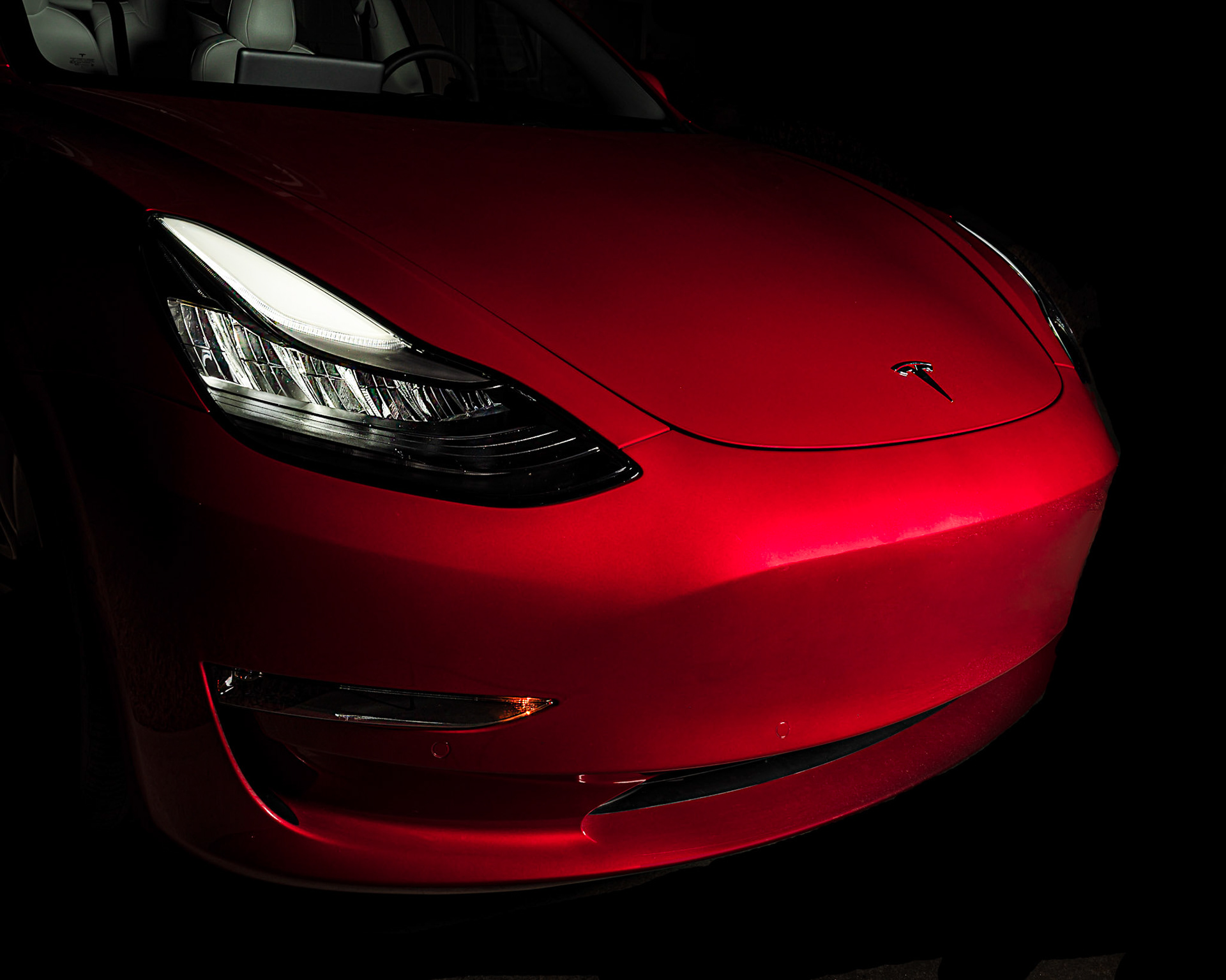 Red Tesla Model 3 at Night