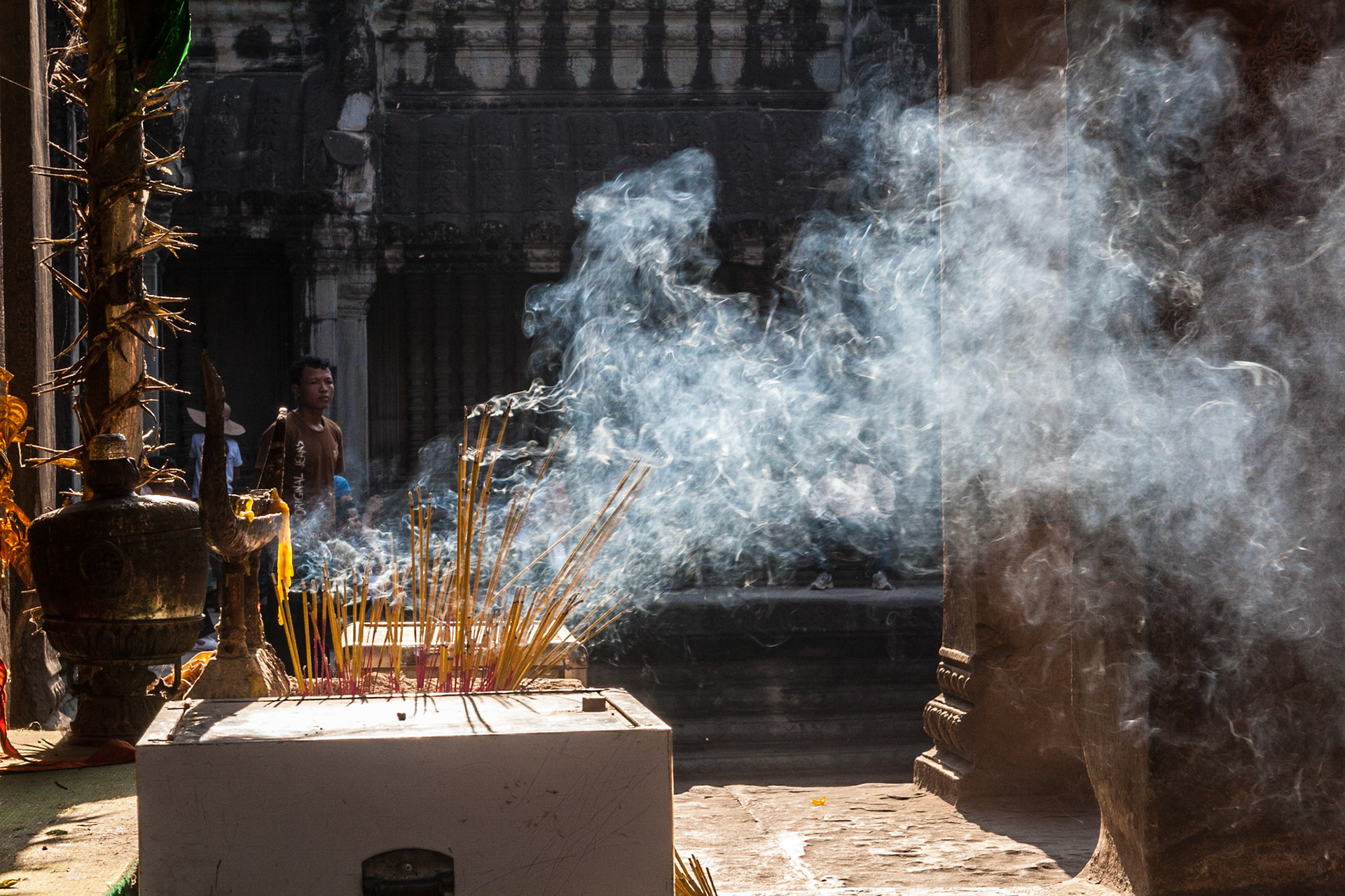 Smoke coming off many small incense at a little shrine in one of the second level galleries in Angkor Wat