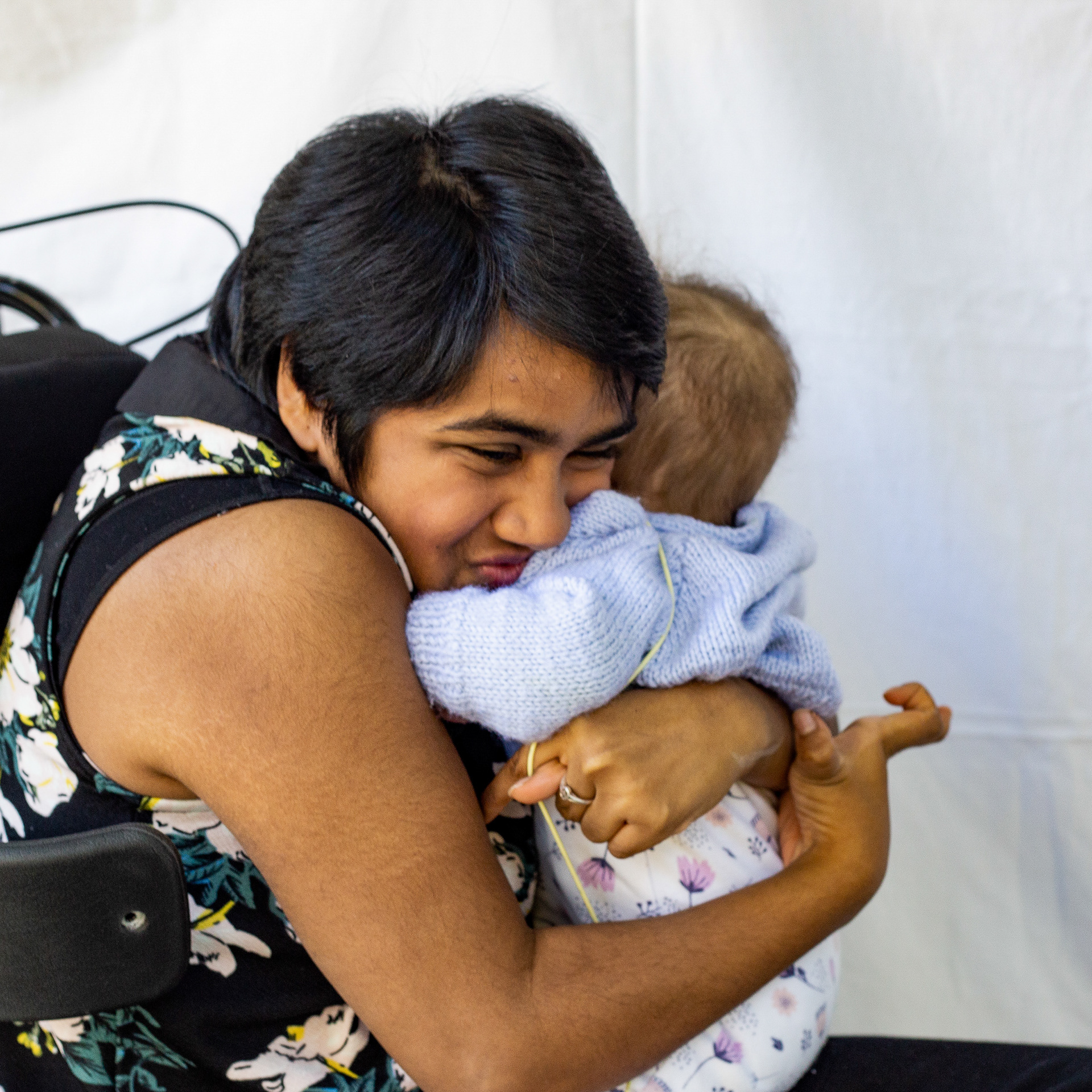 Marusha clutching a little baby in her arms