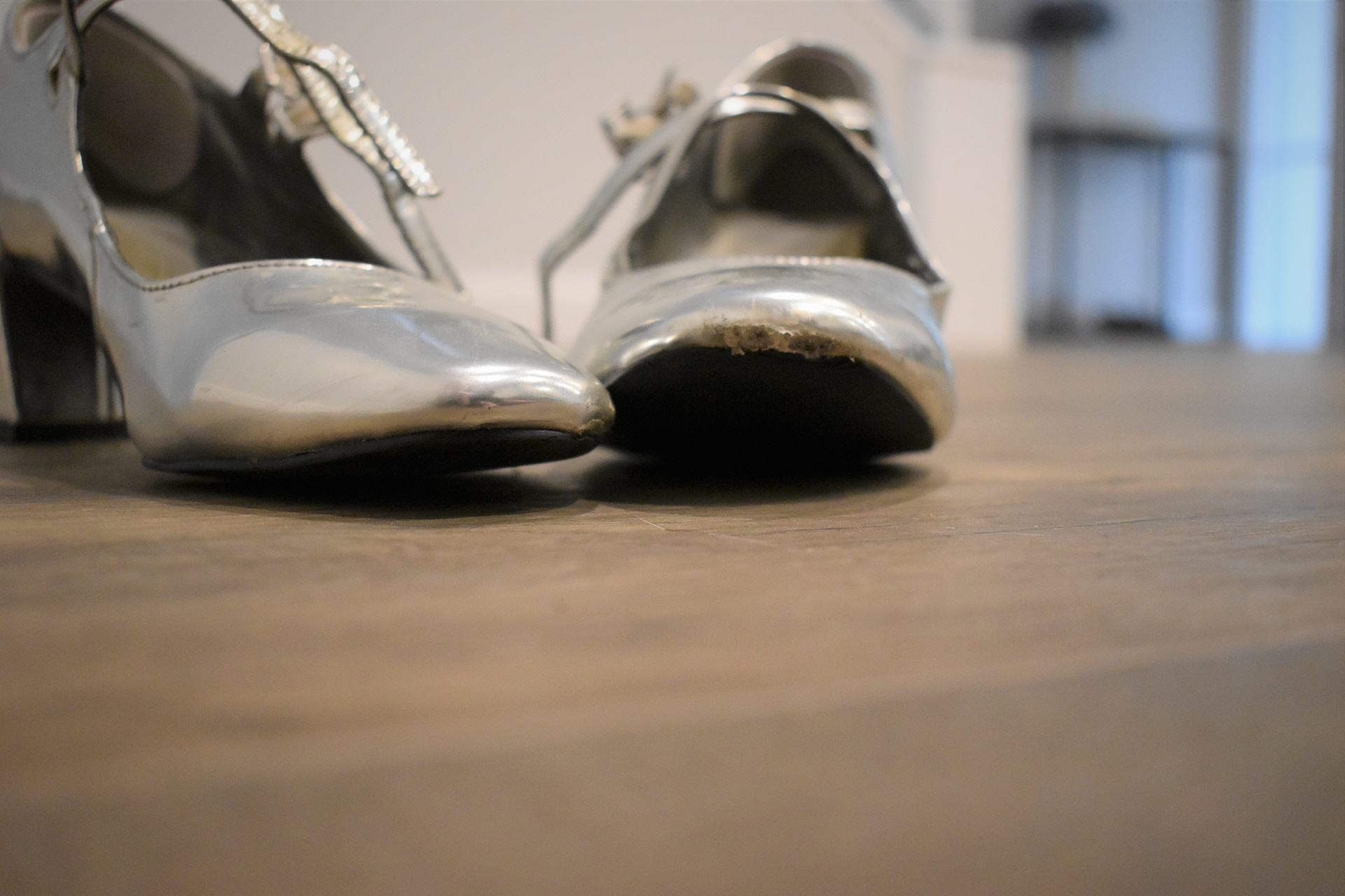 A pair of worn, silver shoes