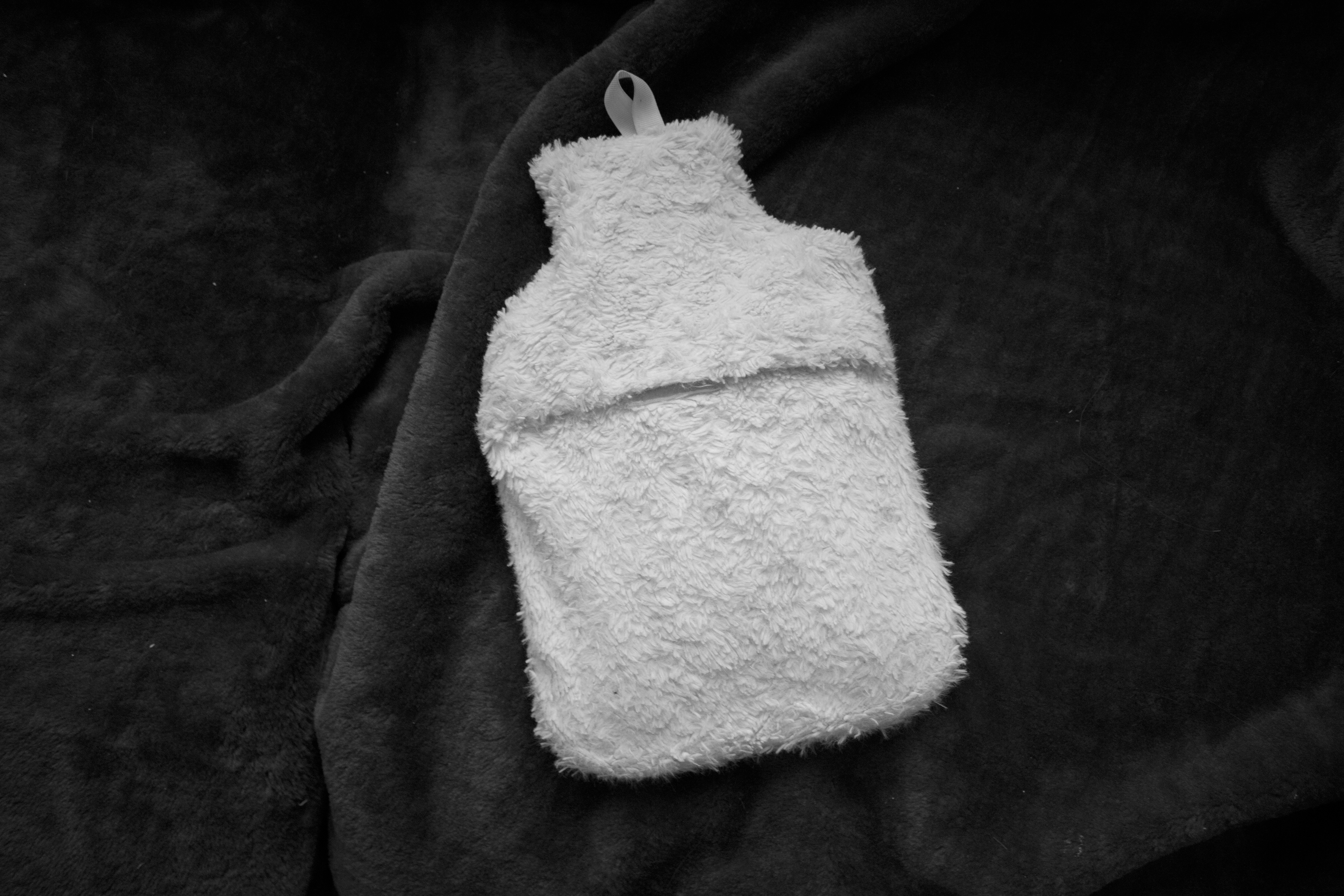 Hot water bottle placed upon a blanket