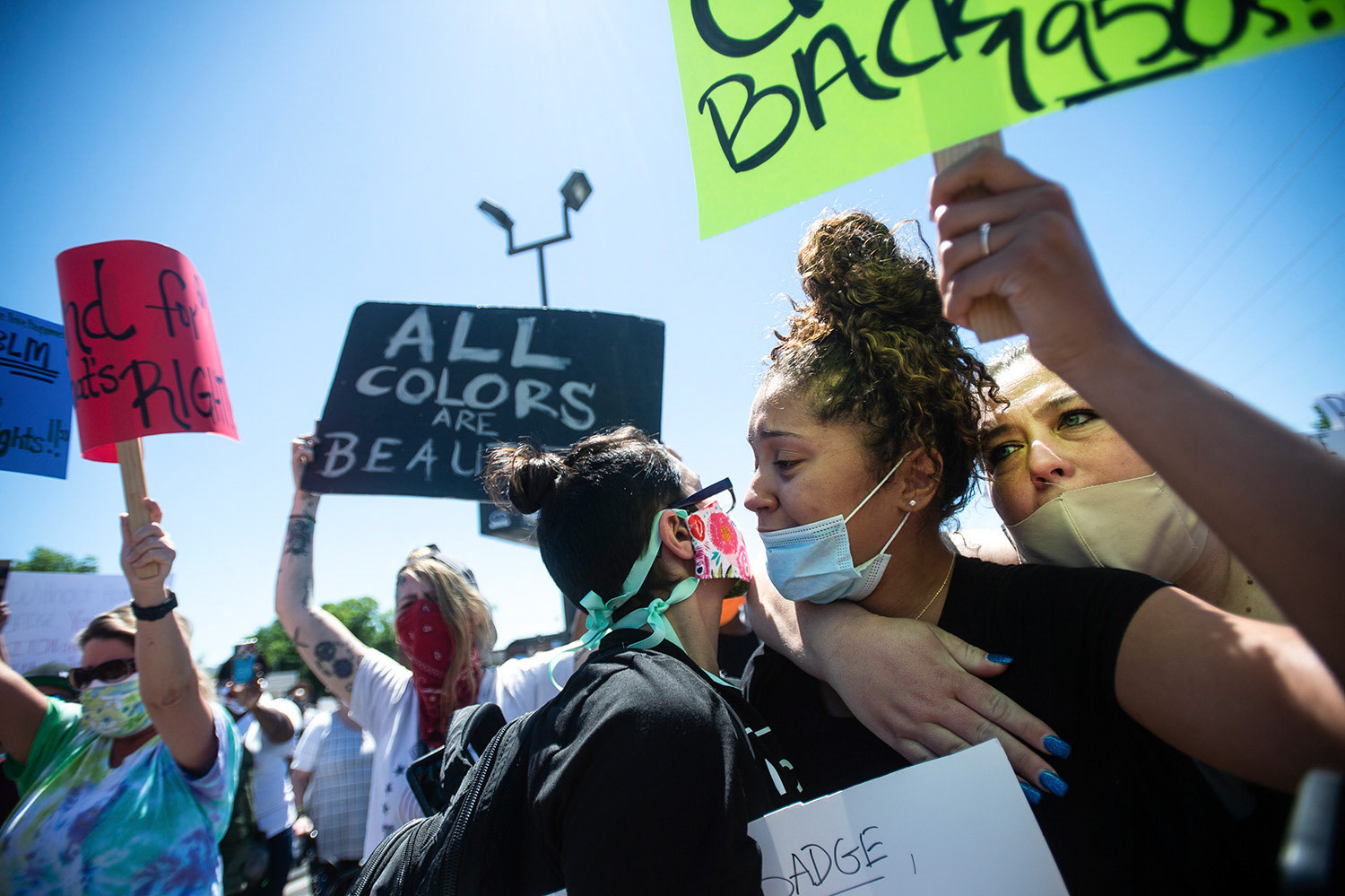 Makyla Bard, right, is comforted by other protestors as she chants, "Say His Name," during a peaceful protest over the death of George Floyd, who died in police custody on Memorial Day in Minneapolis, on Sunday, May 31, 2020, in downtown Decatur, Ala.