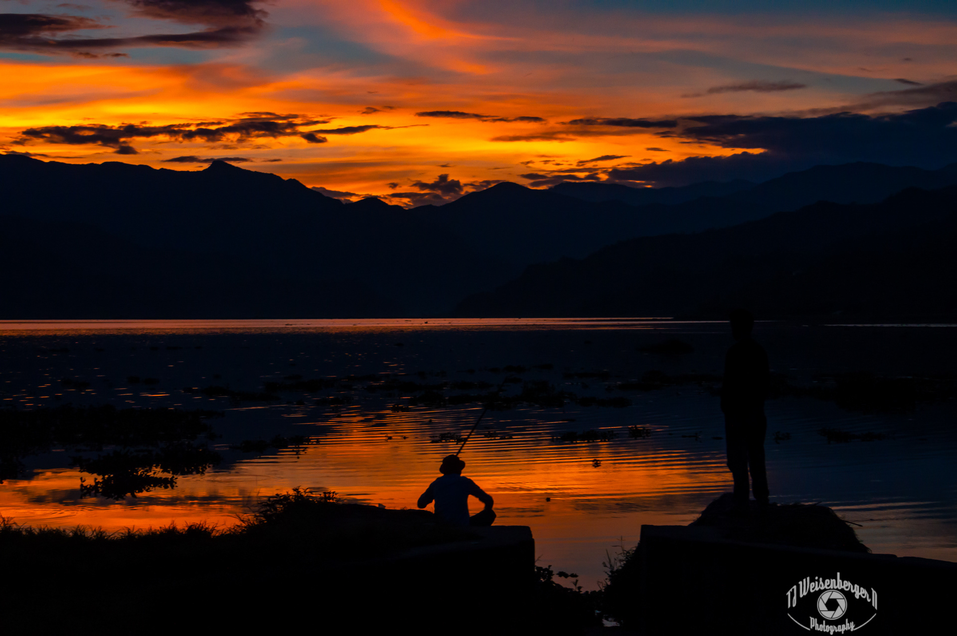 Fishing During Spectacular Sunset Phewa Tal Lake - Pokhara, Nepal; Fewa Lake; Fewa Tal; Fishermen; Mountain; Nepal; People; Phewa Lake; Phewa Tal; Photography; Planet Earth; Pokhara; Reflection; Sunset; Tourism; Travel; Travel Destinations; Water; nature; silhouette; T.J.; TJ; Weiseberger