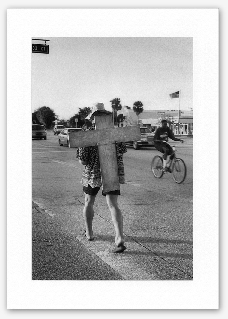 Steve Hanson photography. Man carrying a wooden cross, Florida, USA.