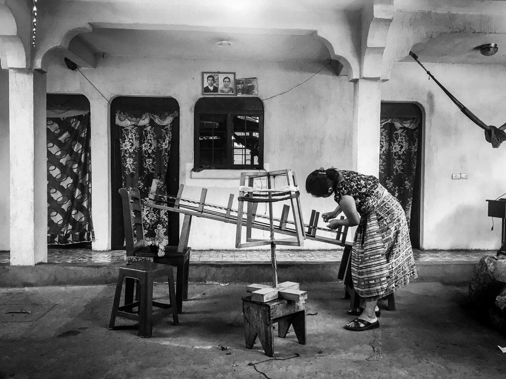 Chusita arranging threads for weaving