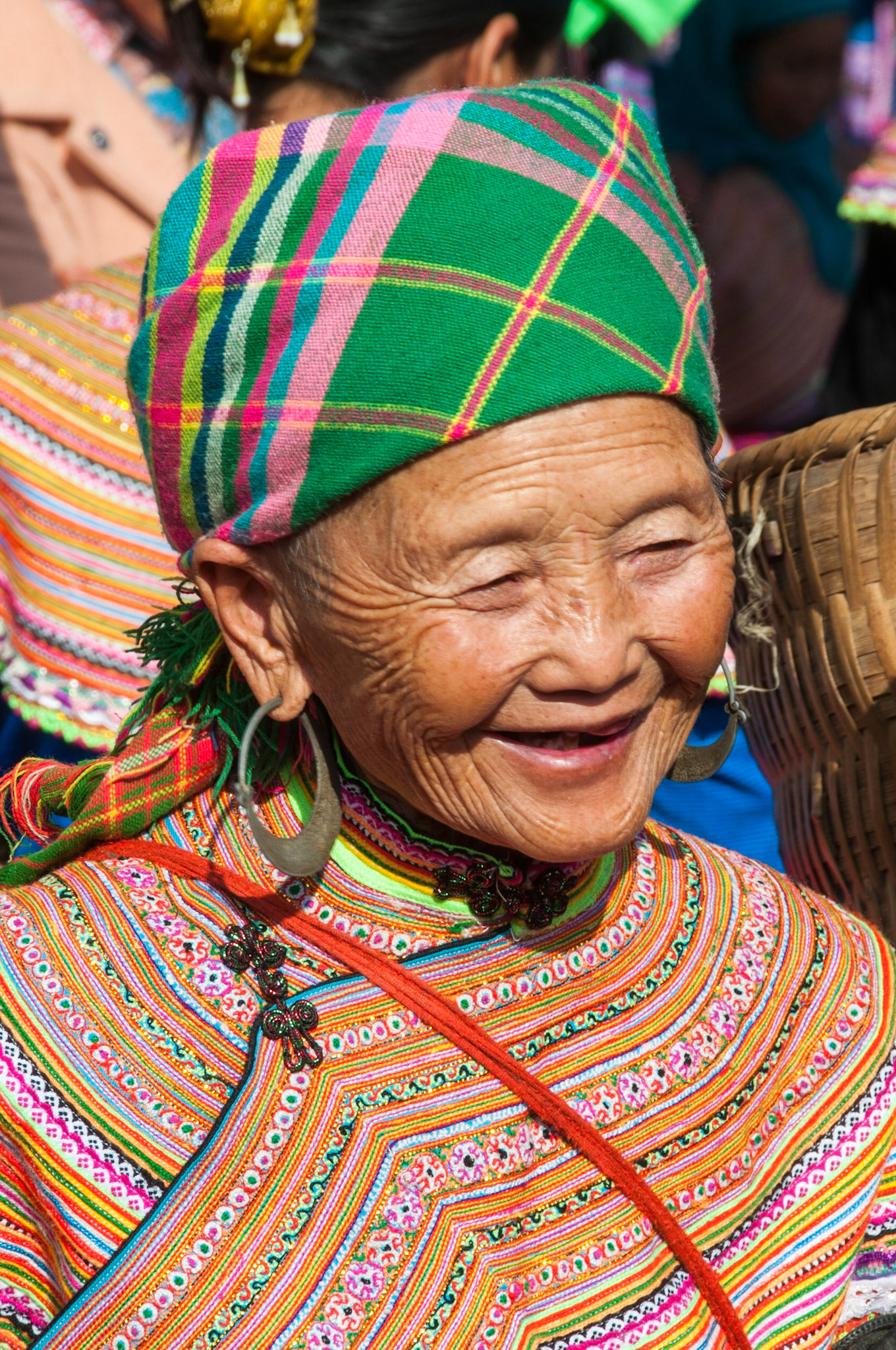 Vietnam, northern. Portrait of a flower Hmong hill tribe woman at the Can Cao Market.