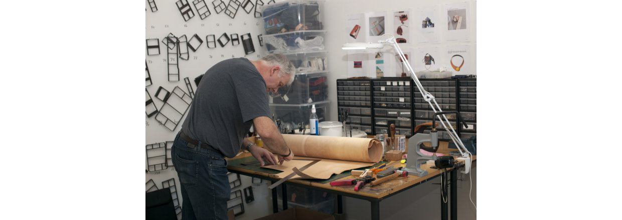 Man working on creating a leather bag in his studio-workshop in Copenhagen.