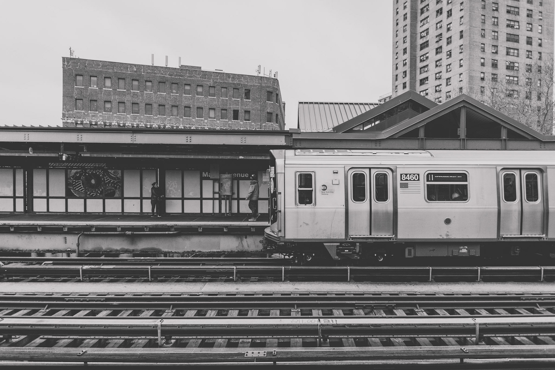 Waiting for the subway train on the elevated subway platform in Williamsburg, Brooklyn.