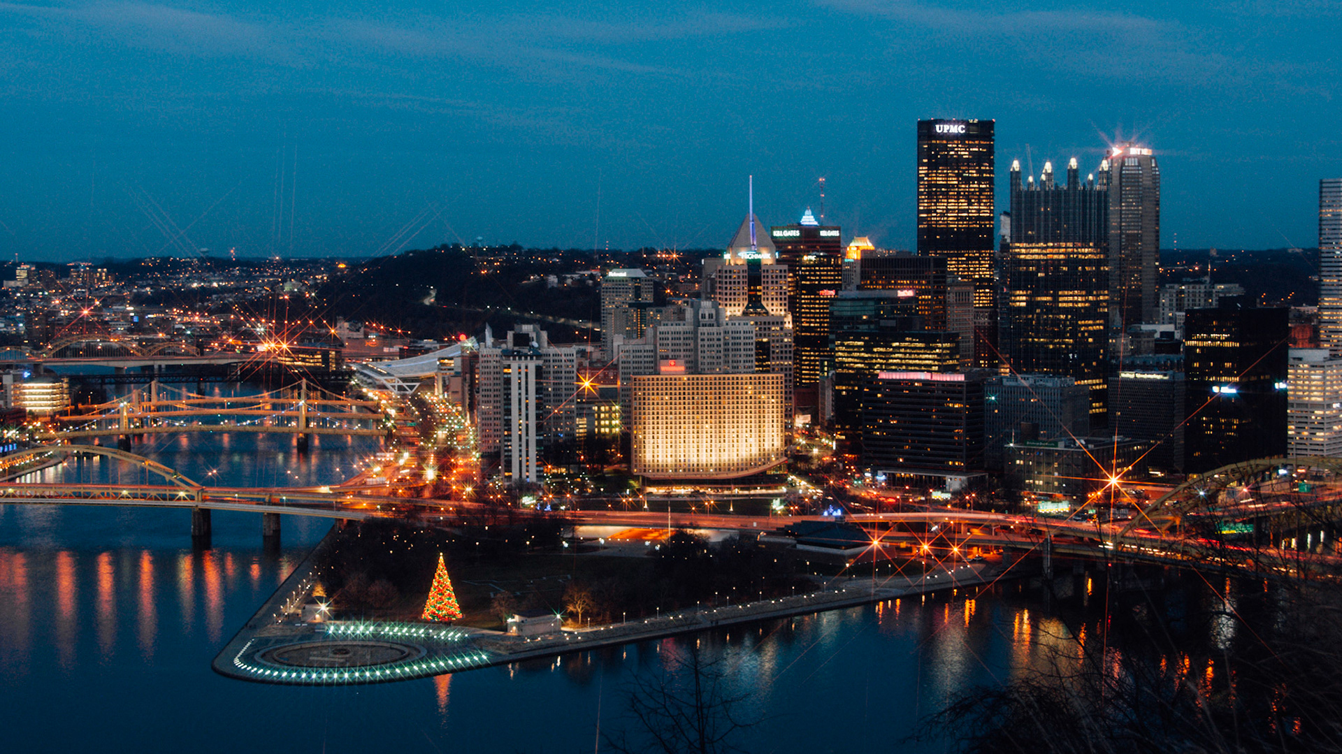The Christmas tree is lit at Point State Park, near the fountain.