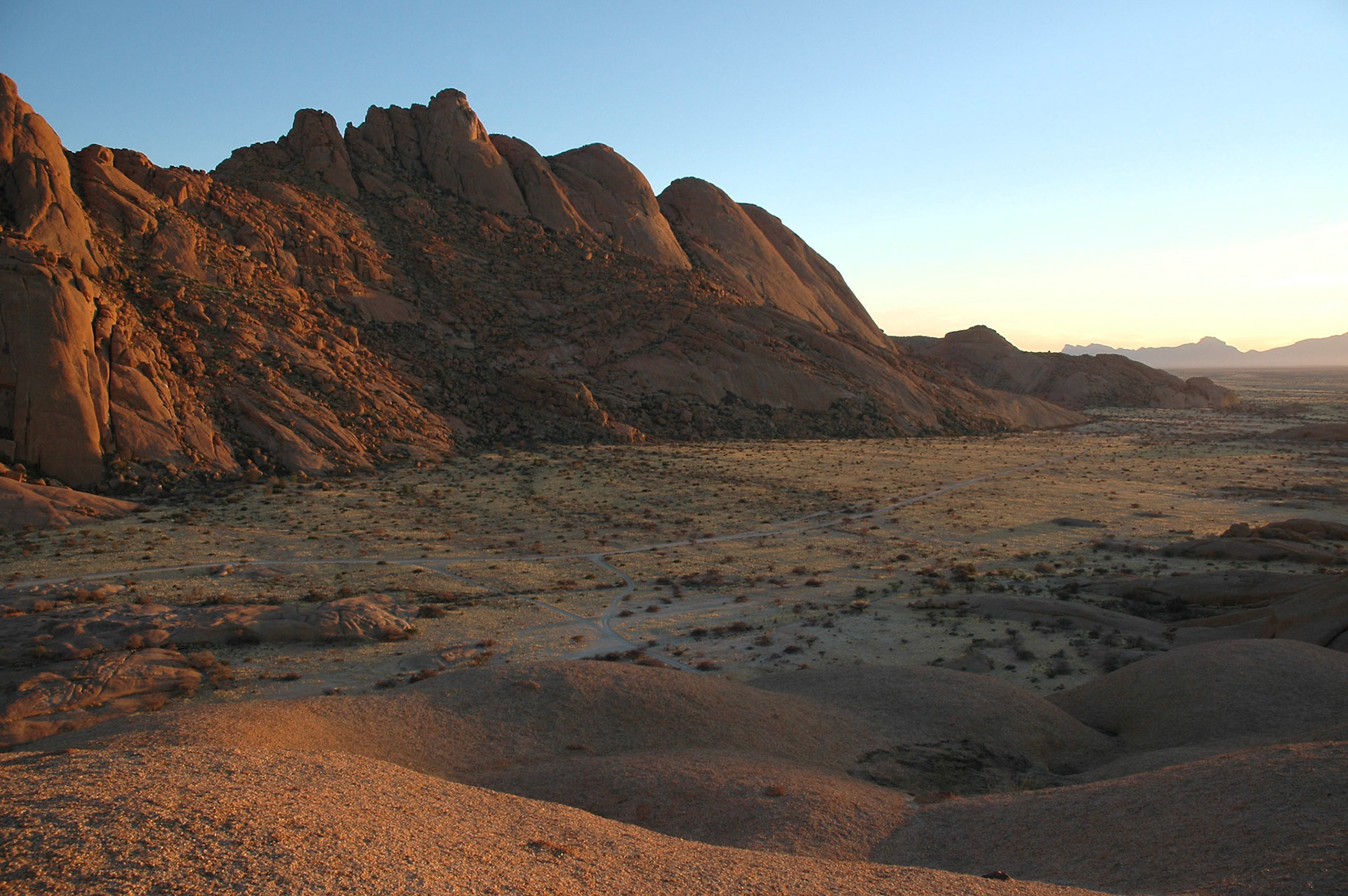 The country is characterized by incredible geological formations. Here strange rocks at Spitzkoppe glowing from early morning light.