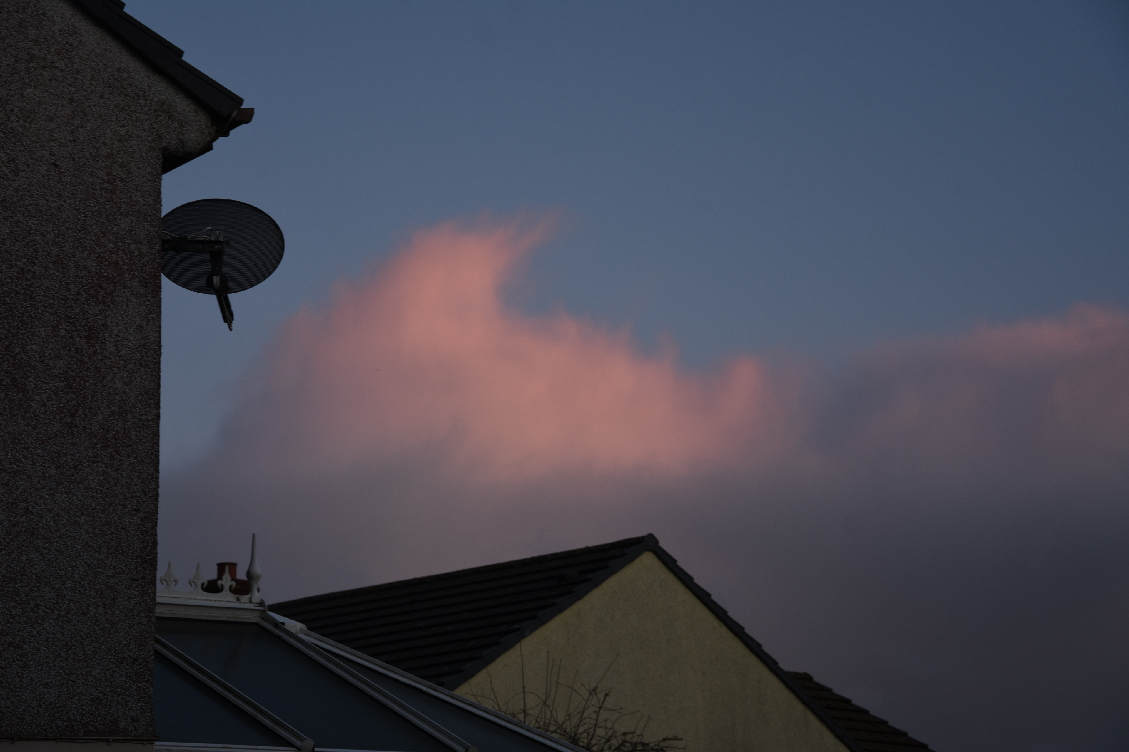 pink clouds at sunset in housing estate by freelance cornish photographer melissa carne