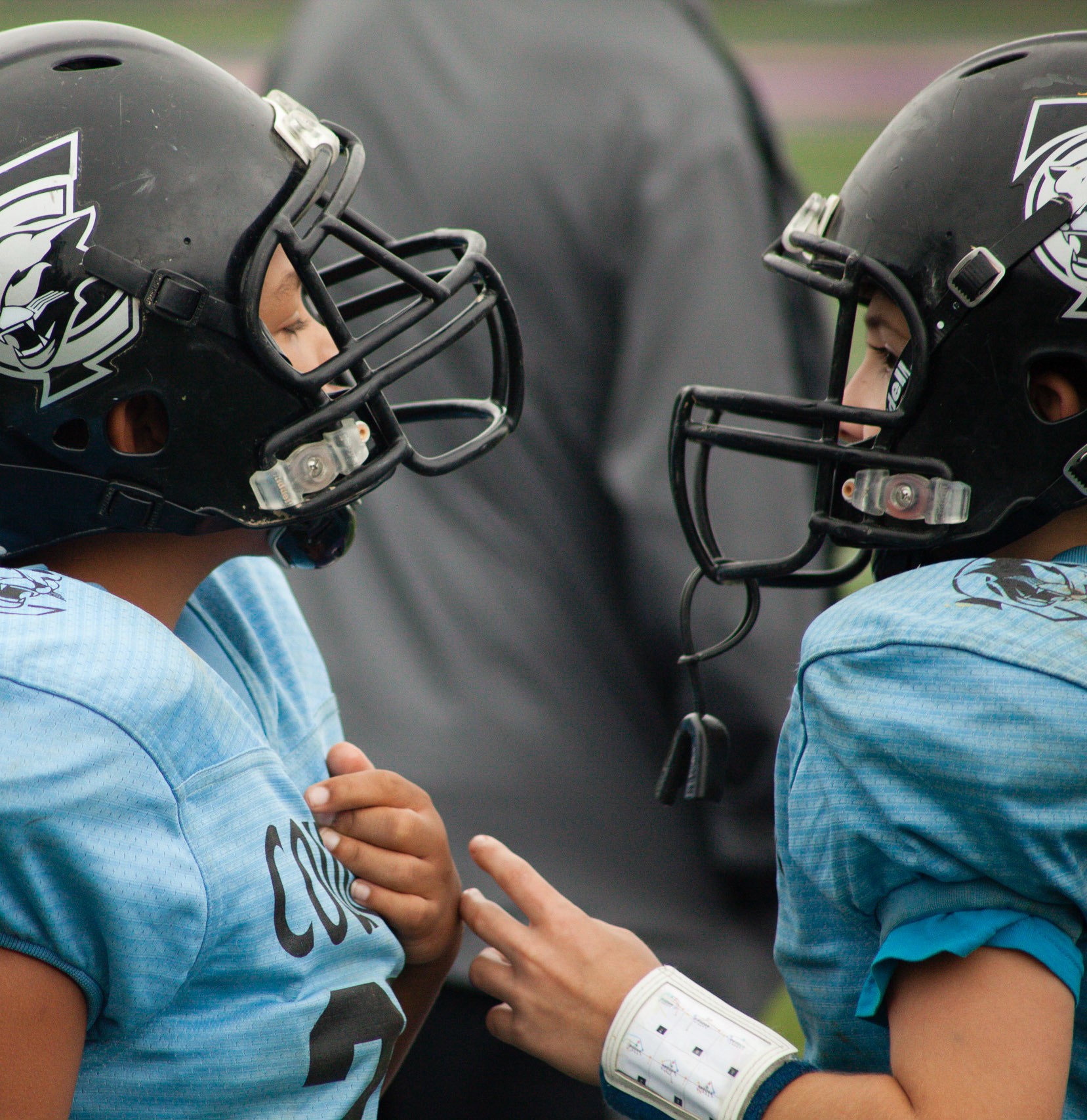 Logan Tooney (R) and teammate Wilson Benedict (L) razz each other about the last play. Gameday. Potosi. 10-01-2016.