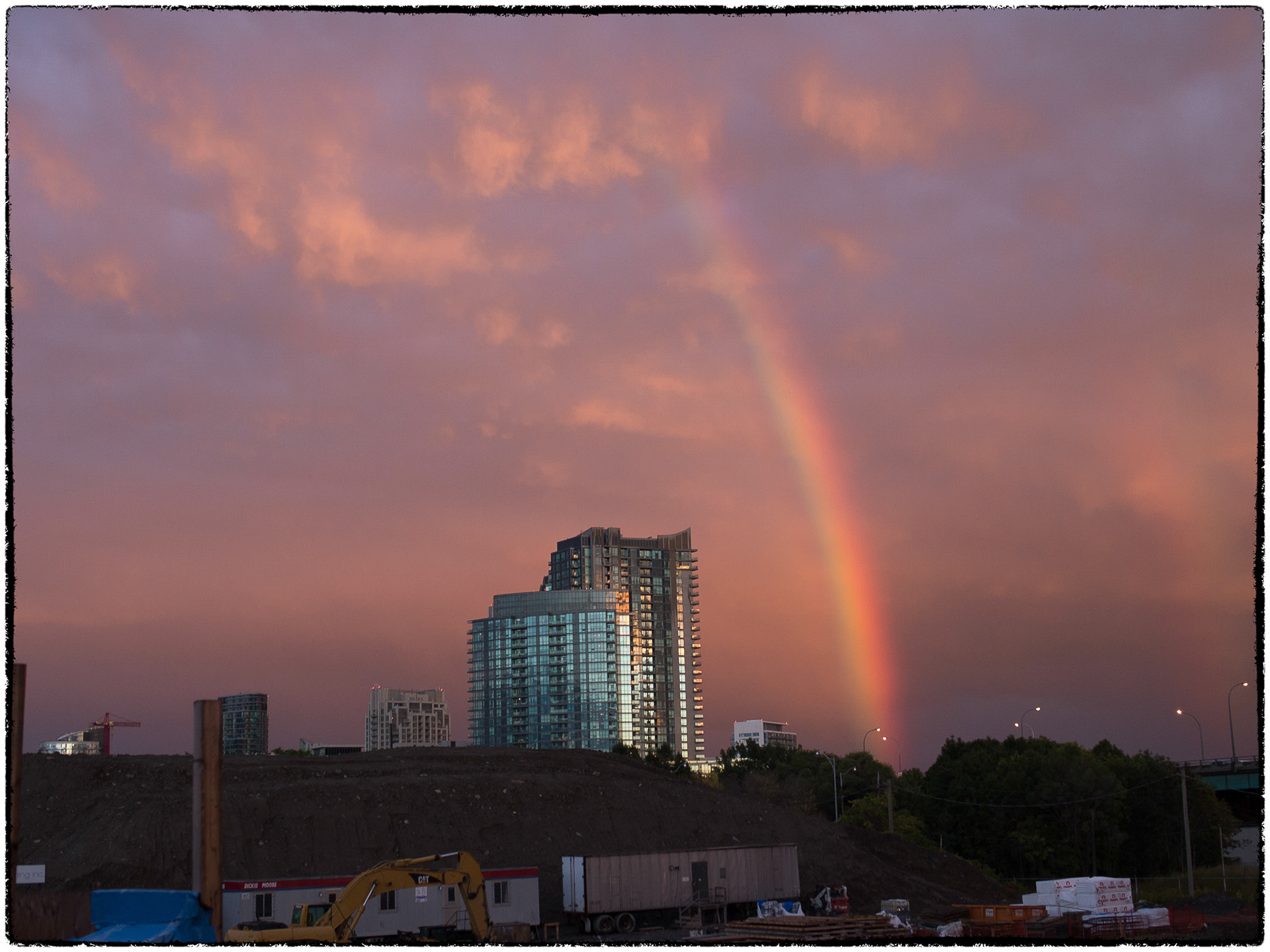Even the dreariest scene can be enlivened by a sunset and a rainbow
